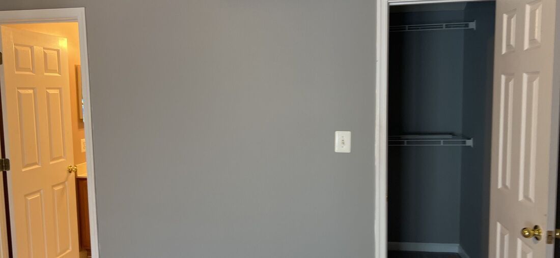 There is a closet in the corner of the room.