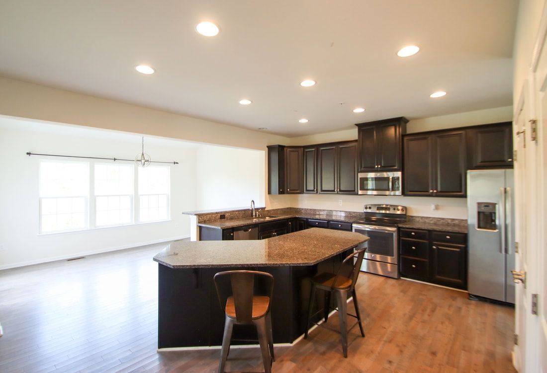 There is a large island in the middle of the kitchen.