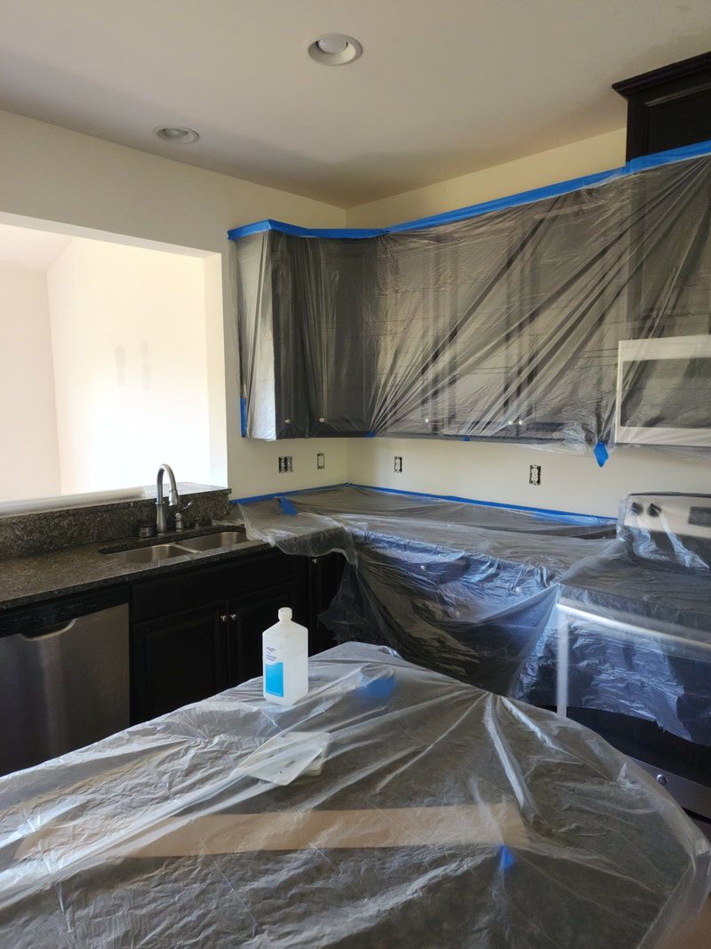 A kitchen with plastic covering the cabinets and counter tops
