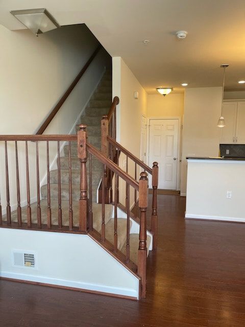 An empty house with stairs leading up to the second floor