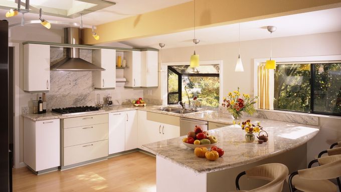 A kitchen with white cabinets and granite counter tops