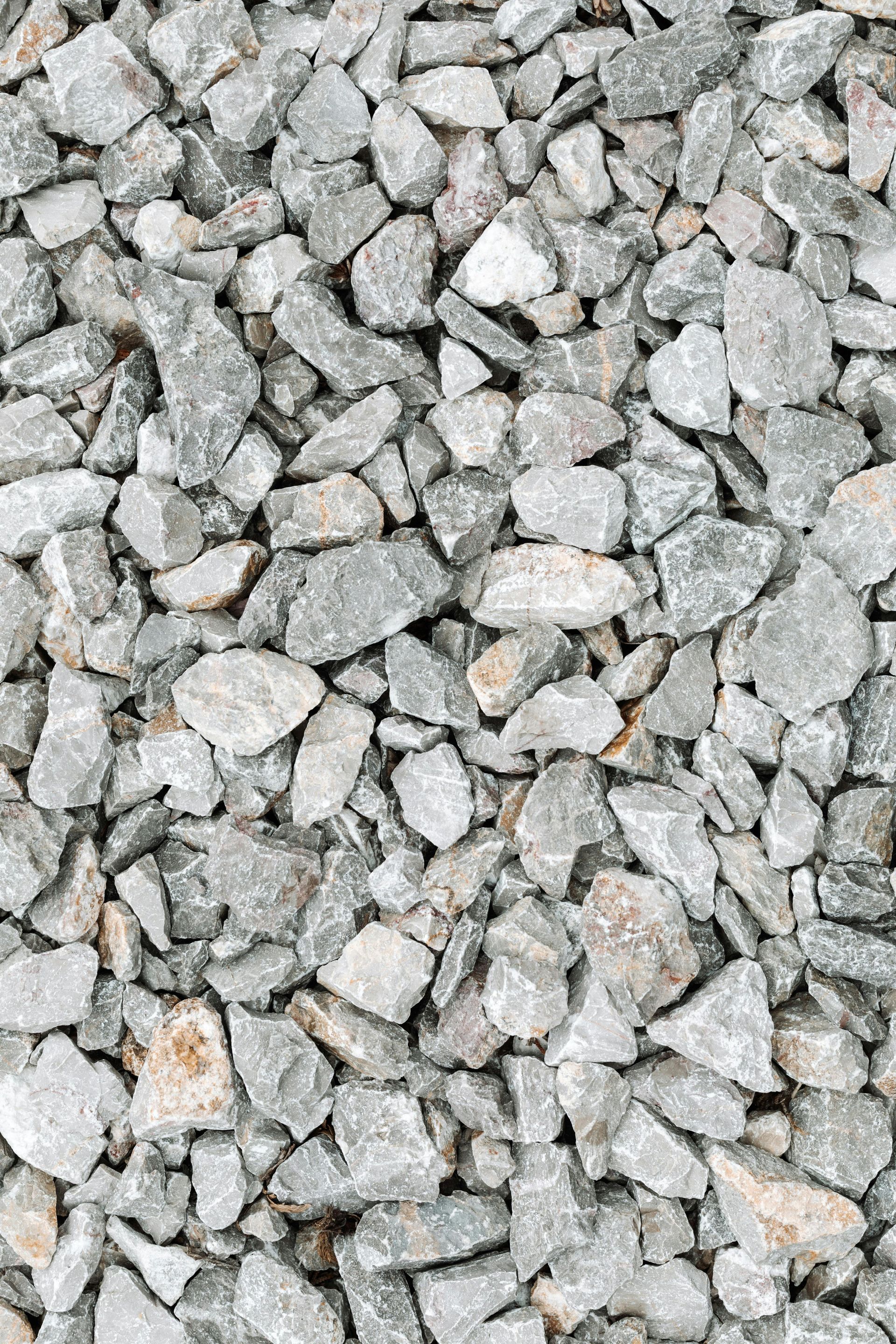 Gray and beige gravel, various sizes, closely packed.