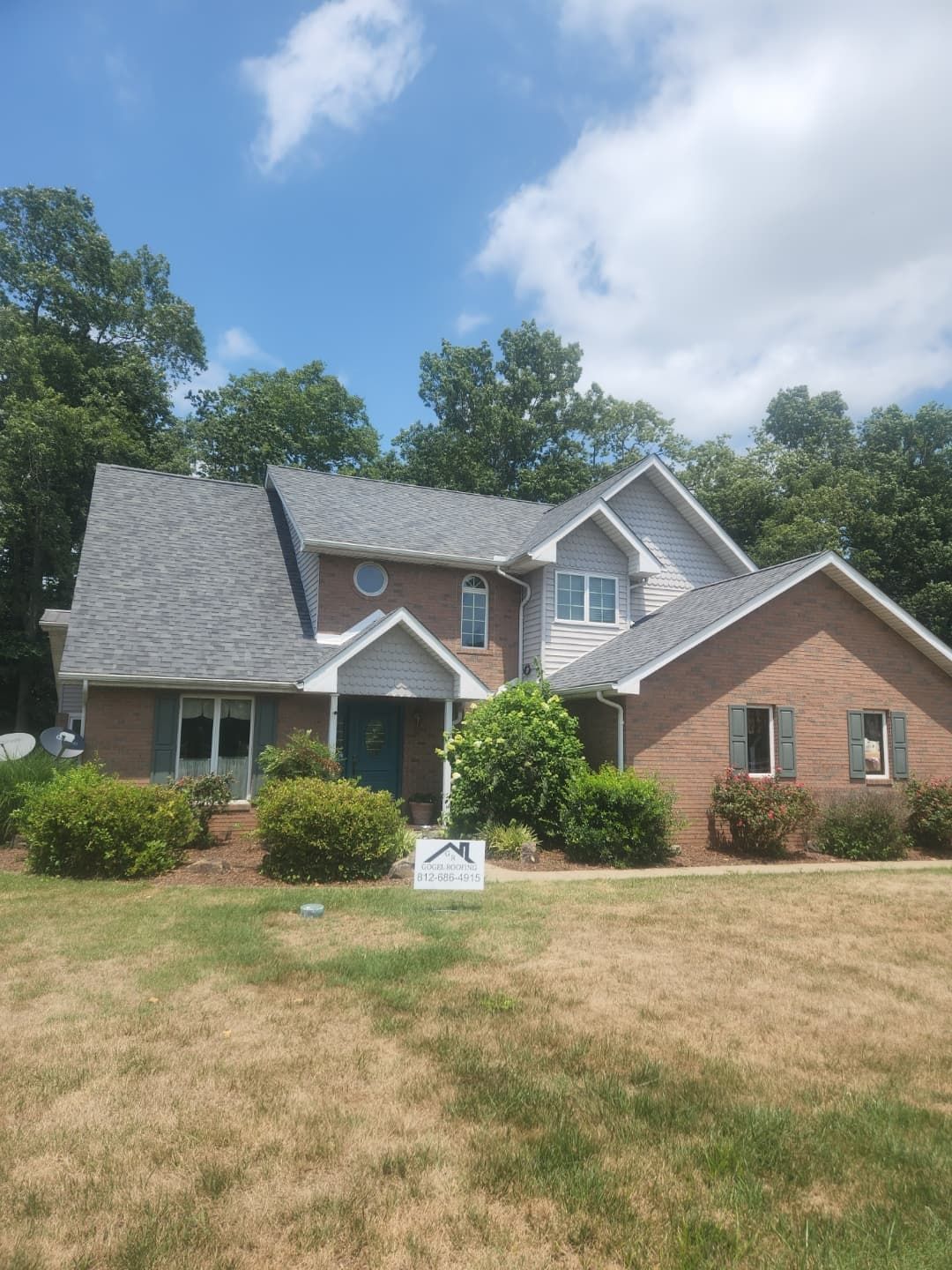 A large brick house with a gray roof