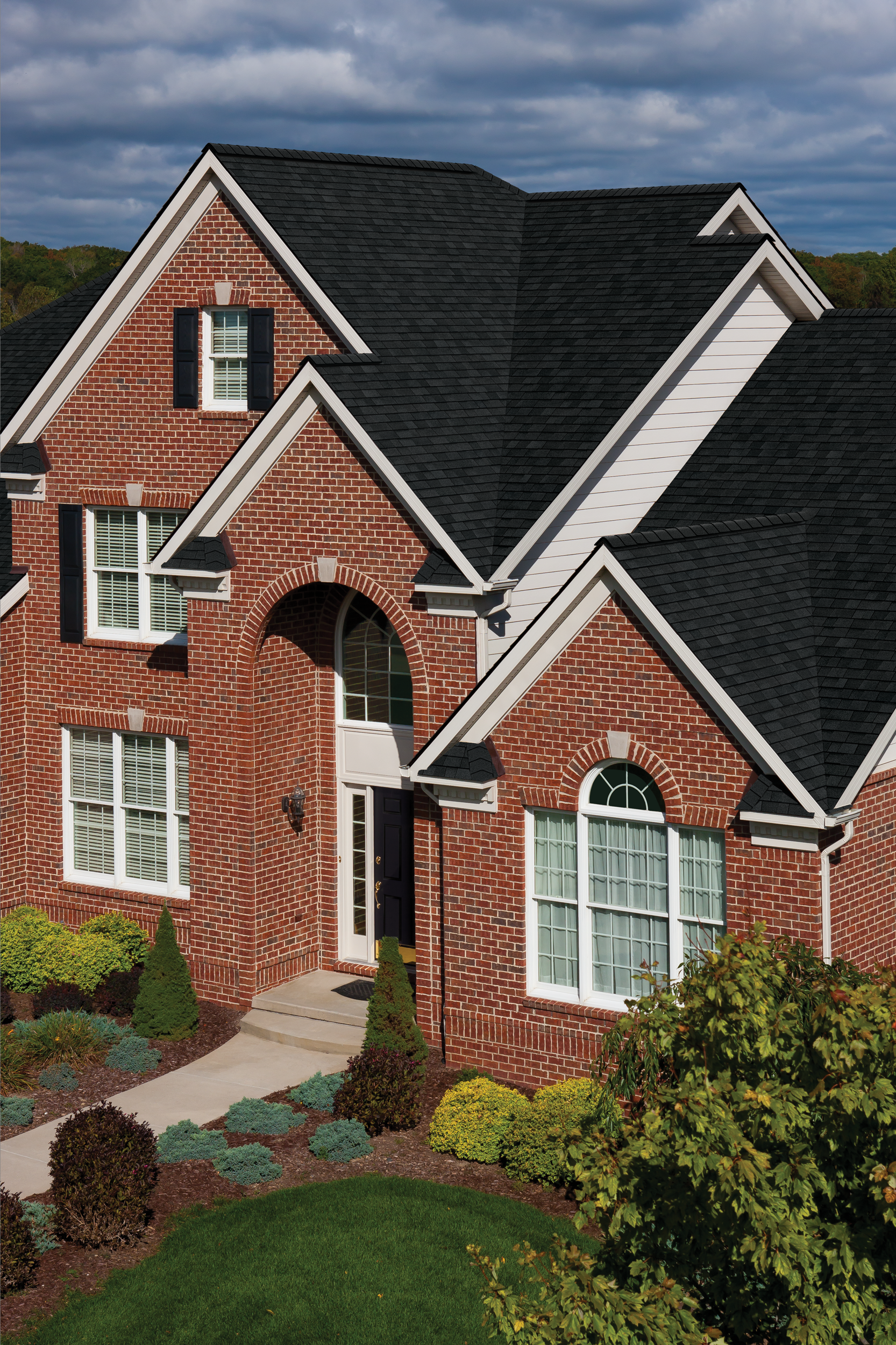 A large brick house with a black roof