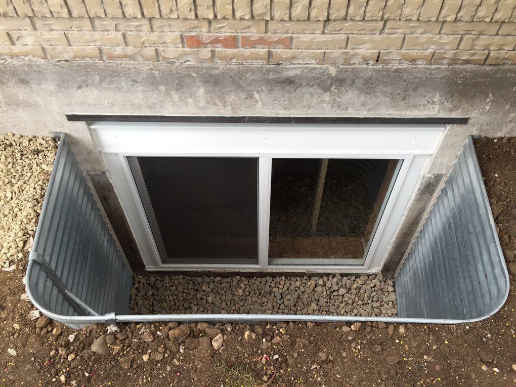 A window in a basement with a screen on it