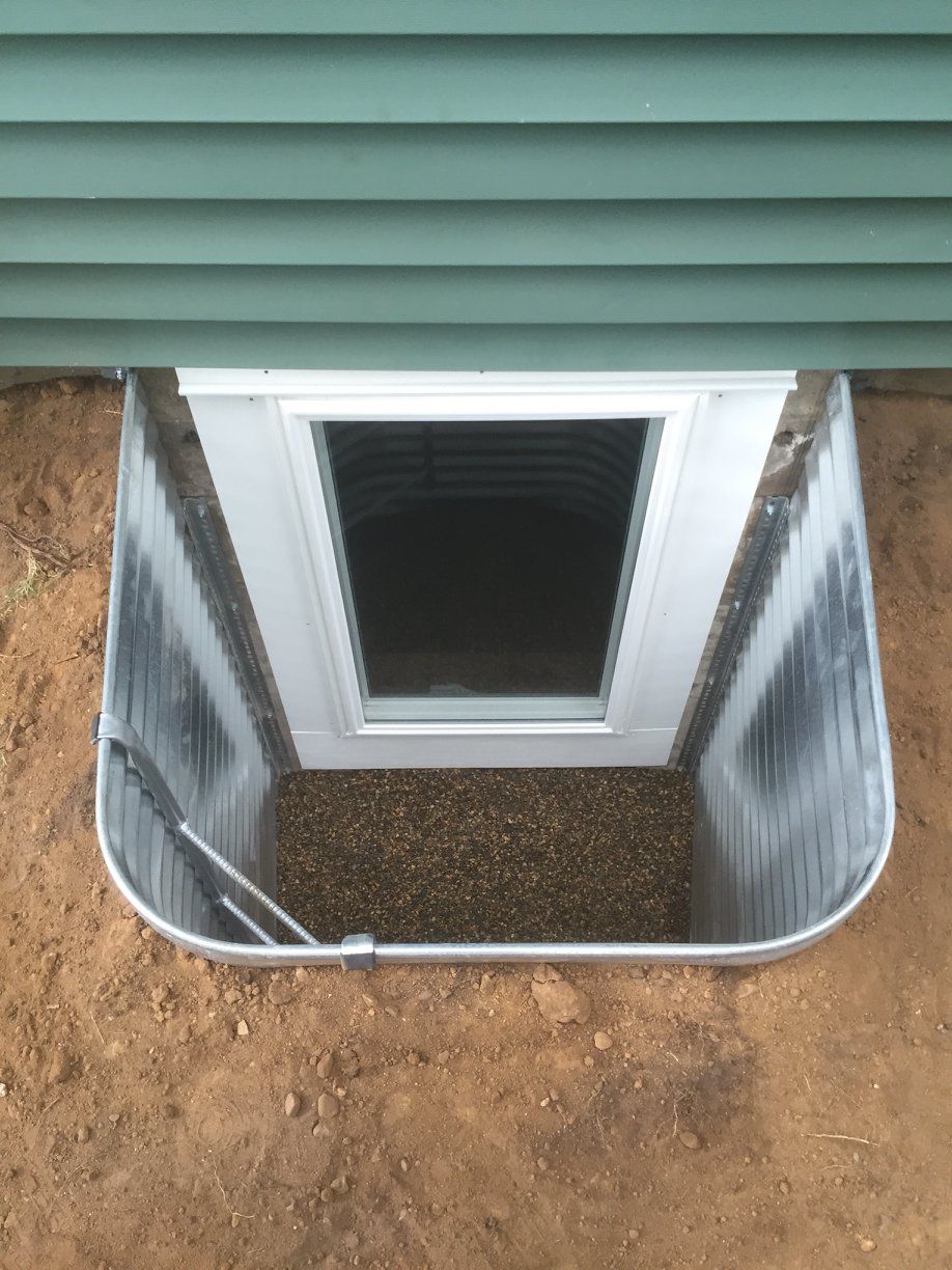 There is a window in the basement of a house.