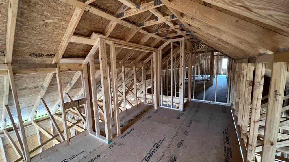 A room in a house under construction with wooden frames.