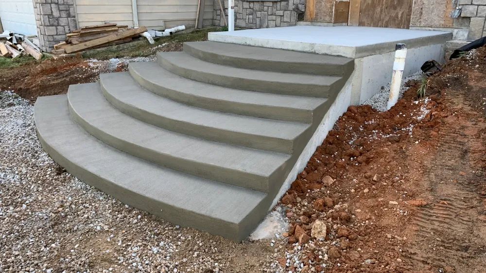 A set of concrete steps are being built in front of a house