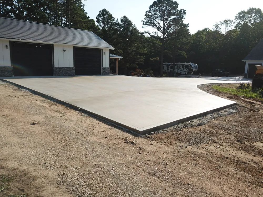 A concrete driveway is being built in front of a house.