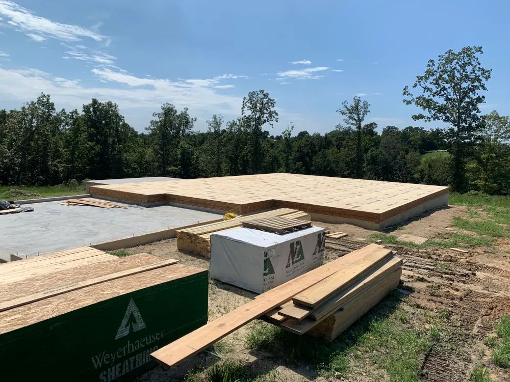 A house is being built in the middle of a field.