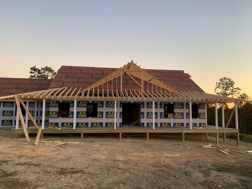 A house is being built with a roof and a porch.