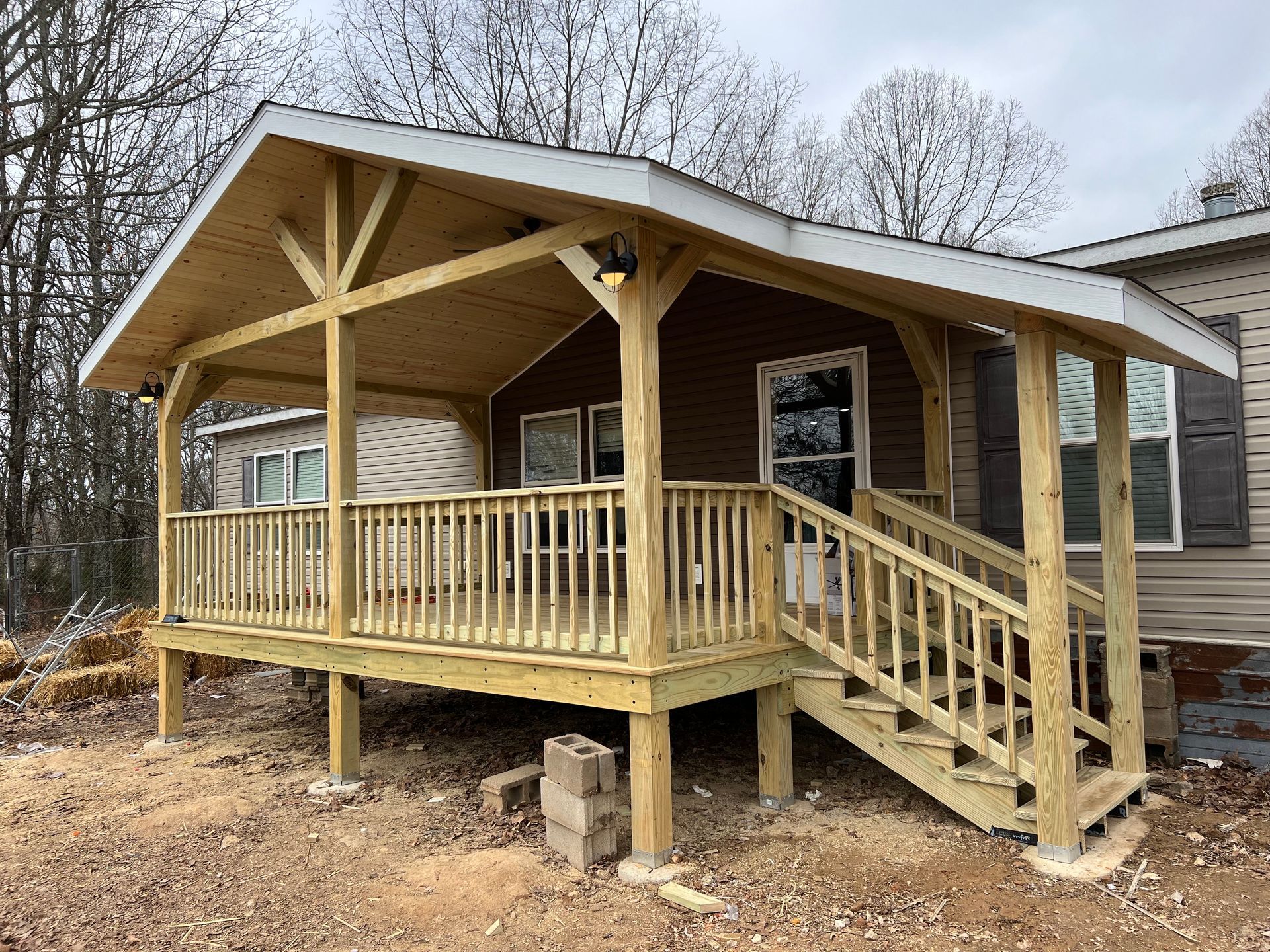 A wooden house is being built in the middle of a forest.