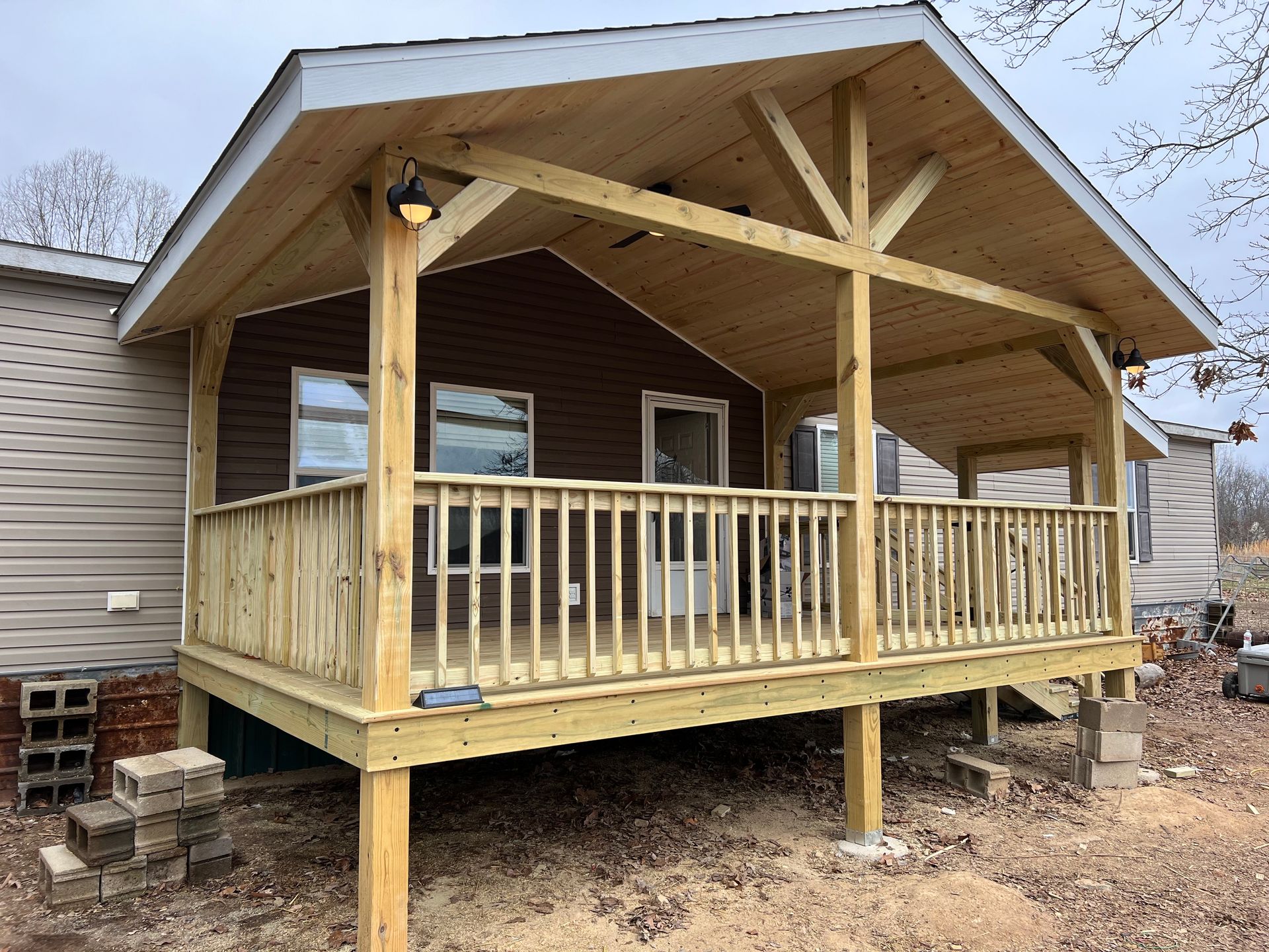 A concrete foundation for a house under construction with a blue tarp on top of it.
