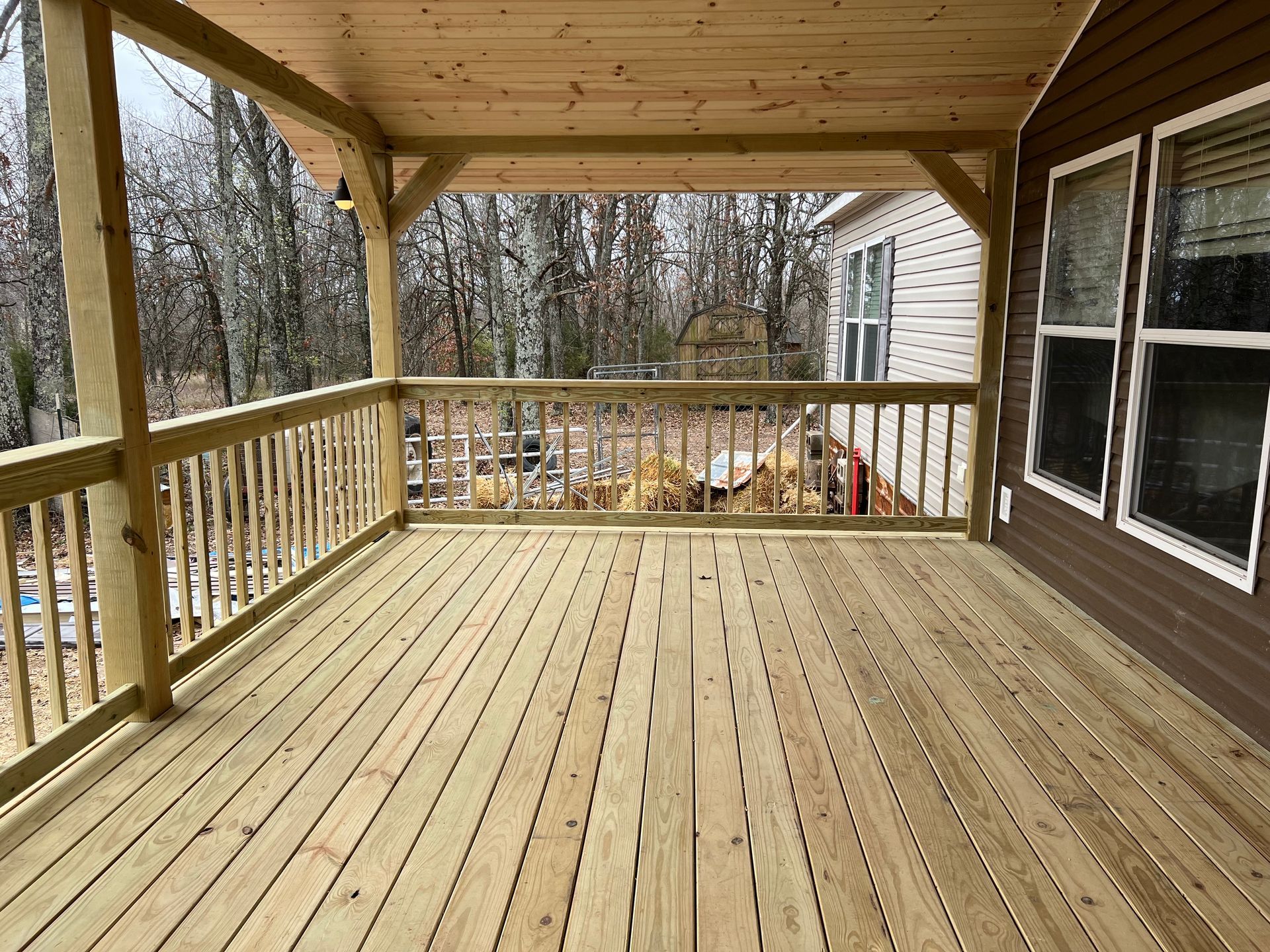 A concrete driveway next to a house with a white door.