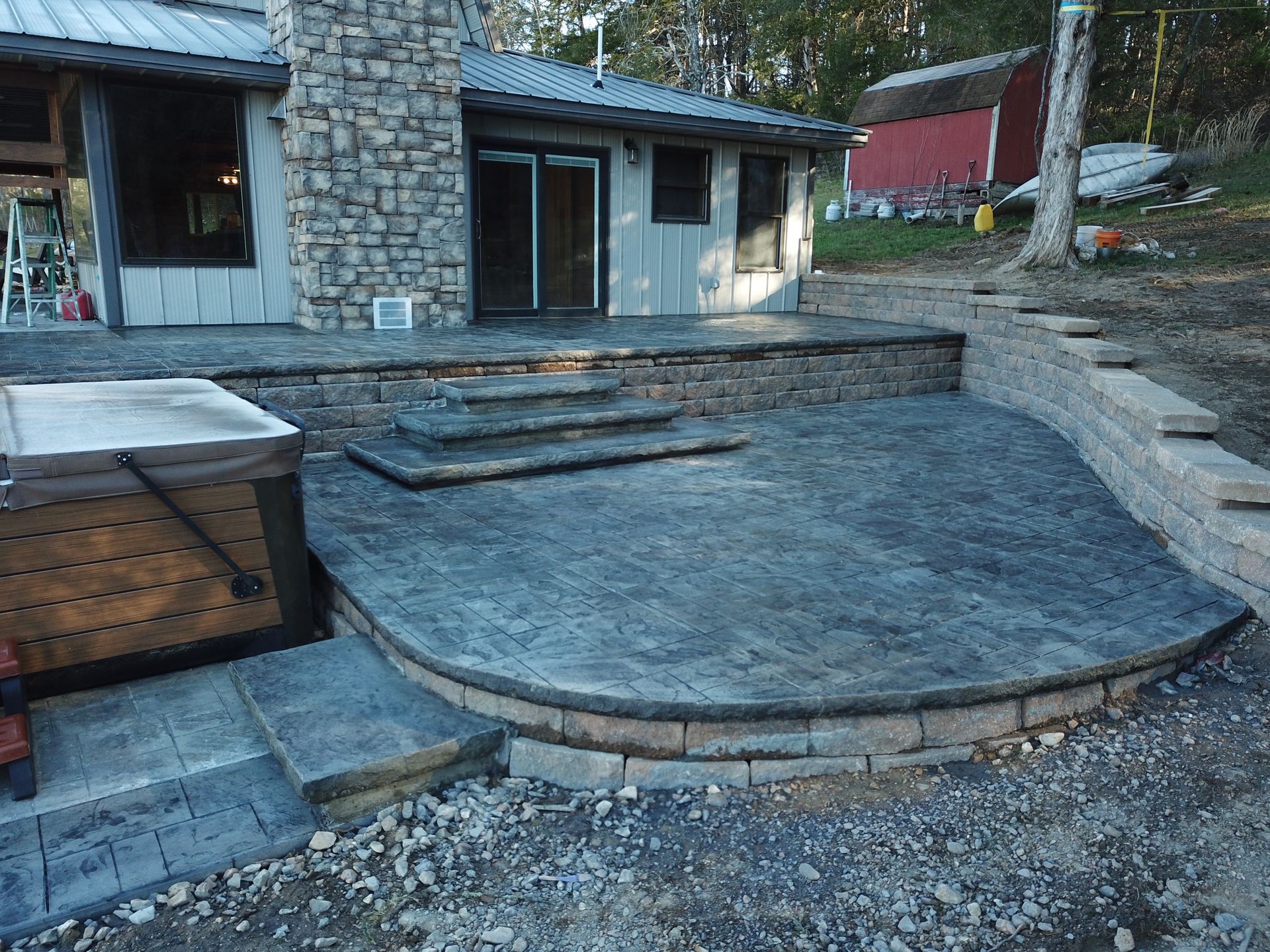 A concrete foundation is being built in a gravel lot.