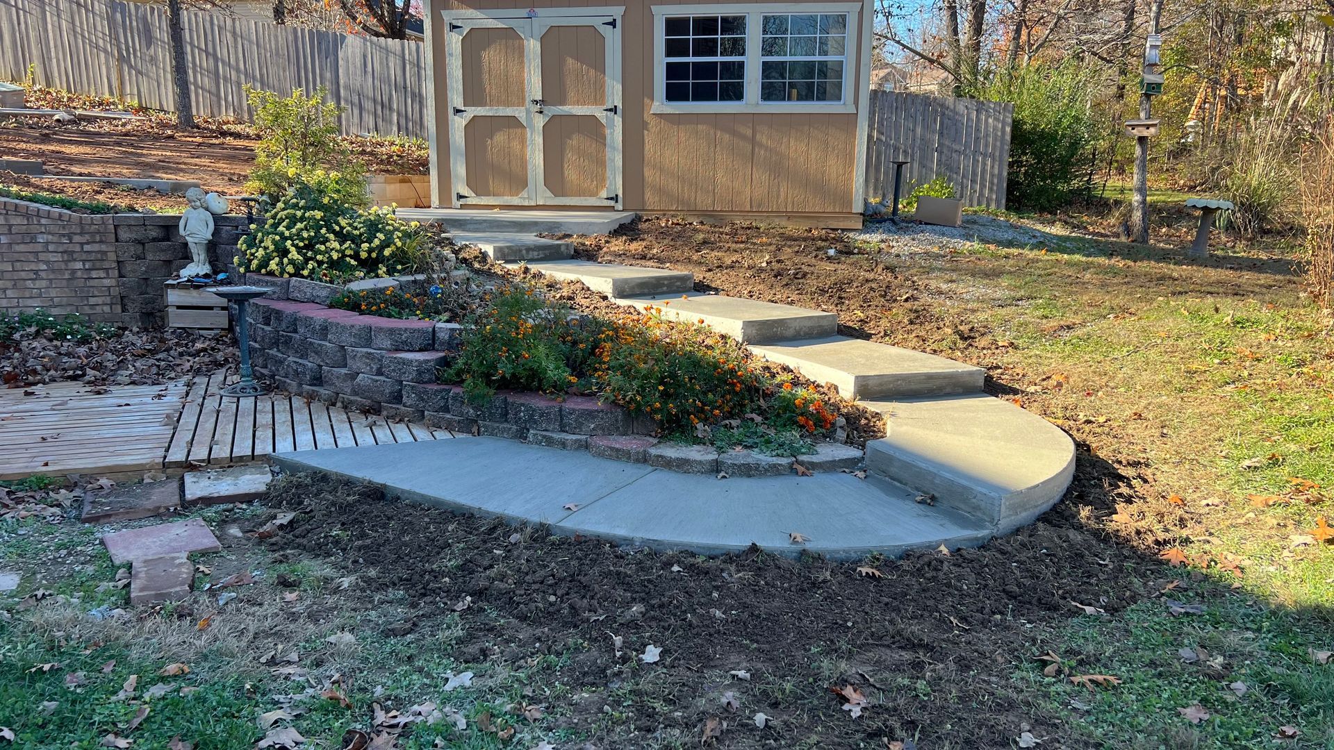 A white house with a concrete walkway leading to it.