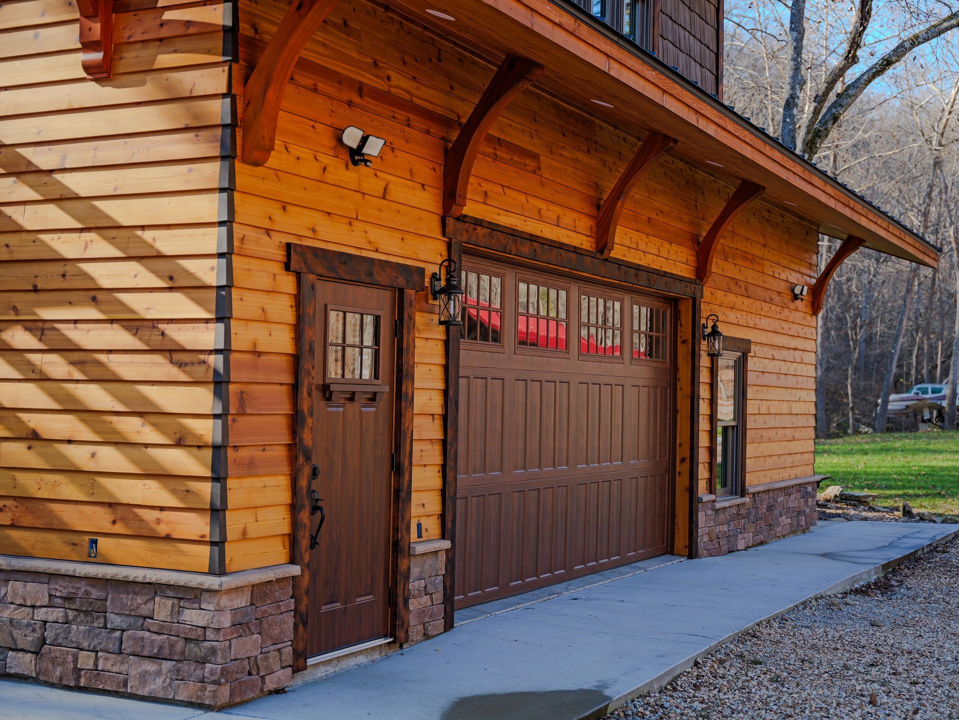 A large concrete wall is being built in front of a house.