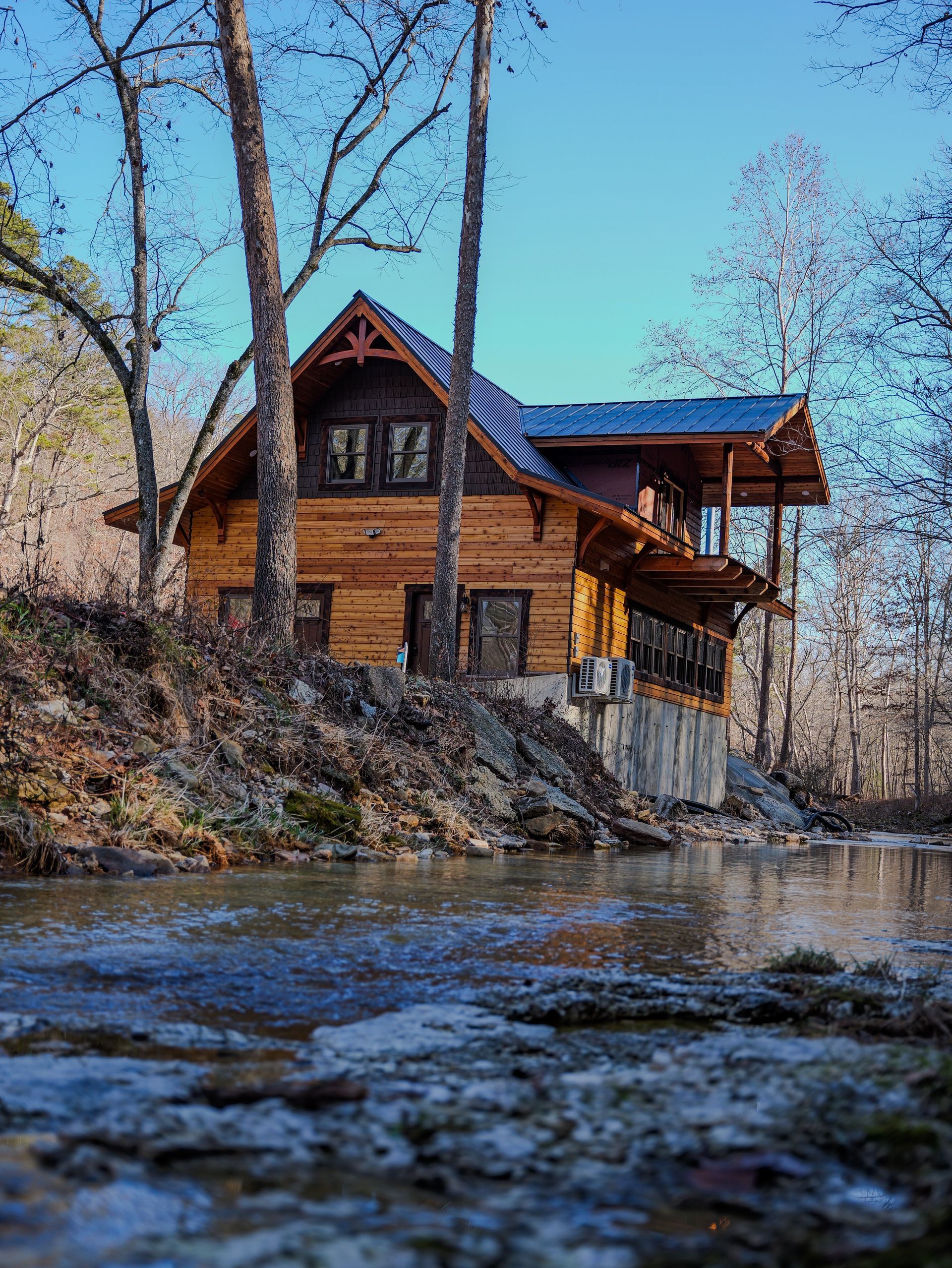 A house is being built in a field with a blue sky in the background.
