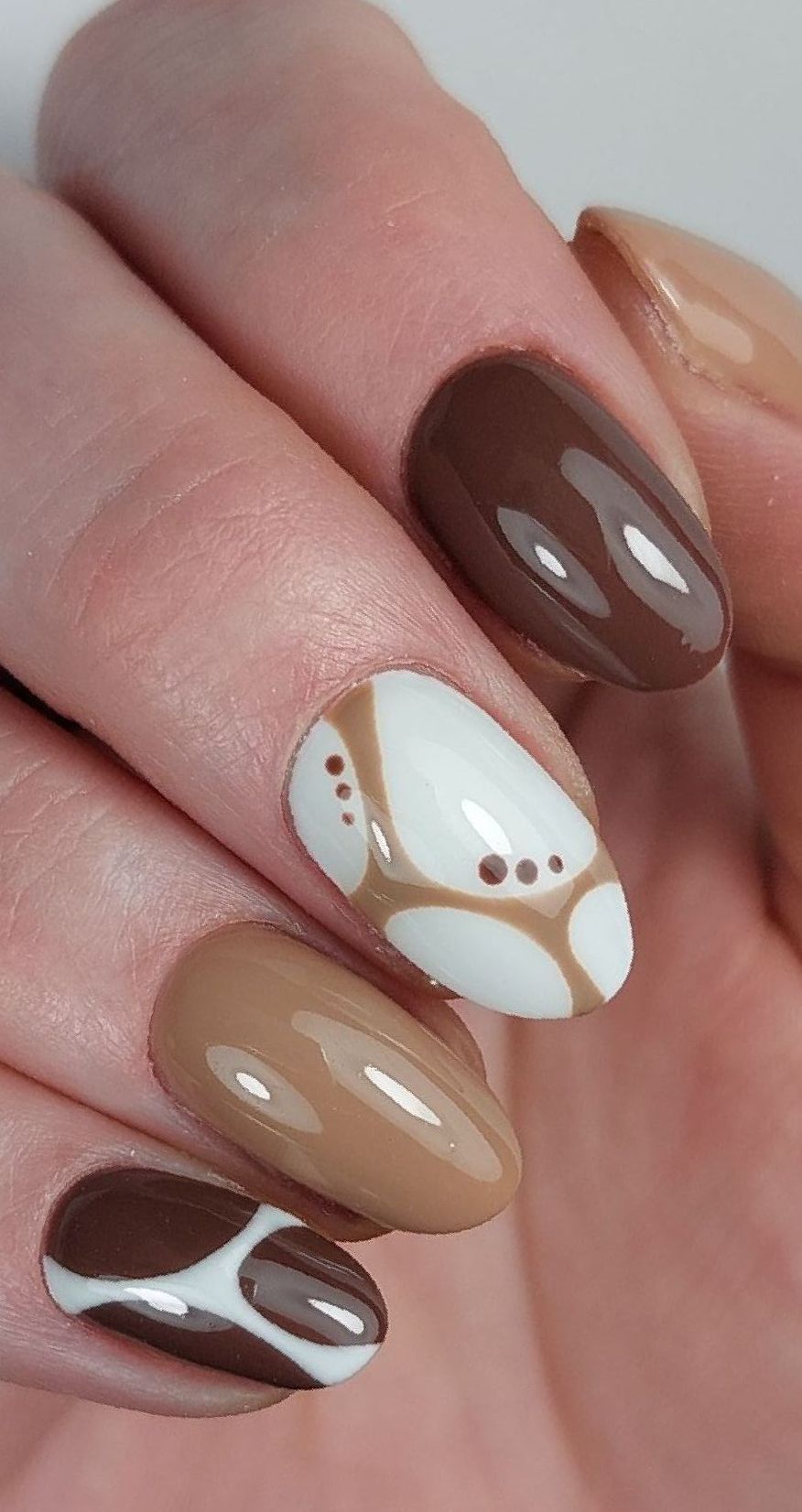 Een close-up van nagels met een trendy bruin en wit ontwerp in nagelstudio Nailservice Rianne in Sint Annaparochie