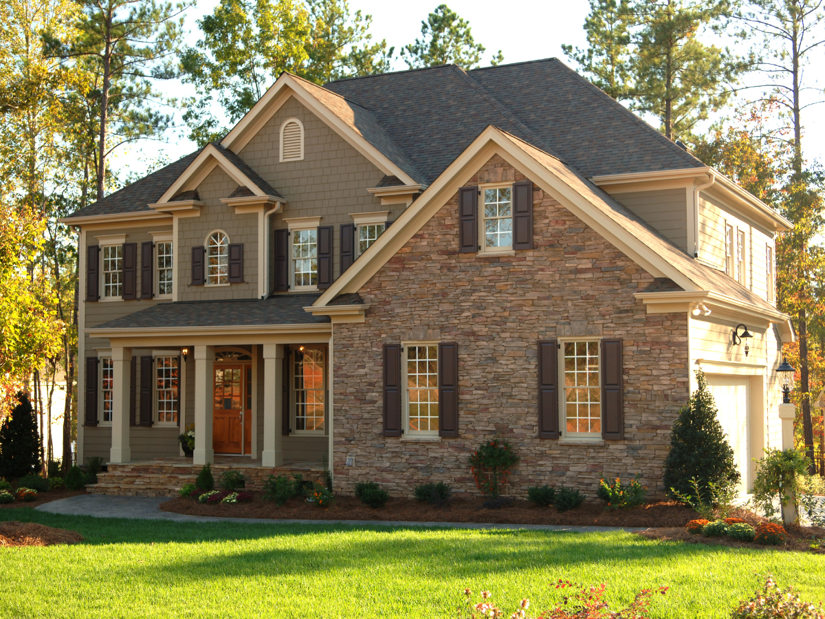 A row of houses with white garage doors and windows.