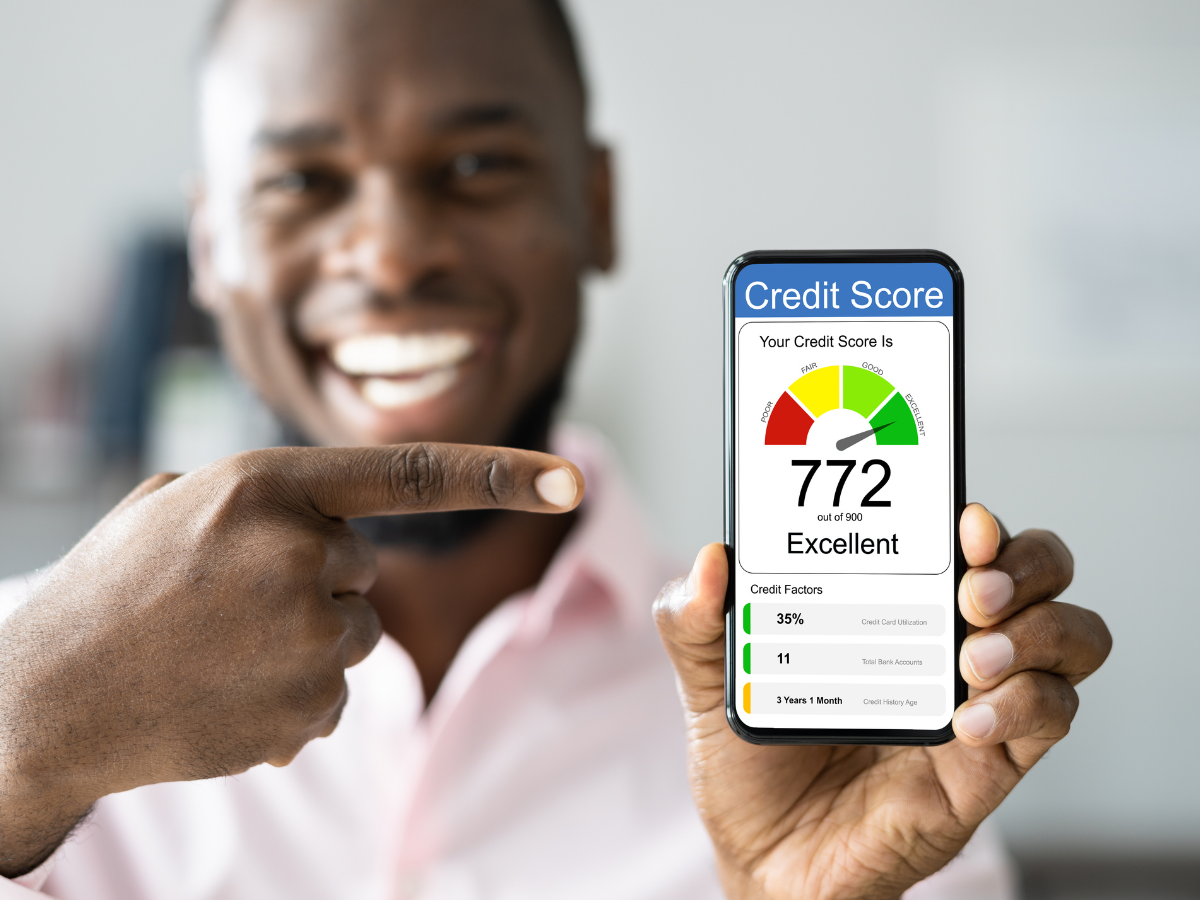 A man is holding a cell phone with a credit score on it. A man is holding a cell phone with a credit score on it.