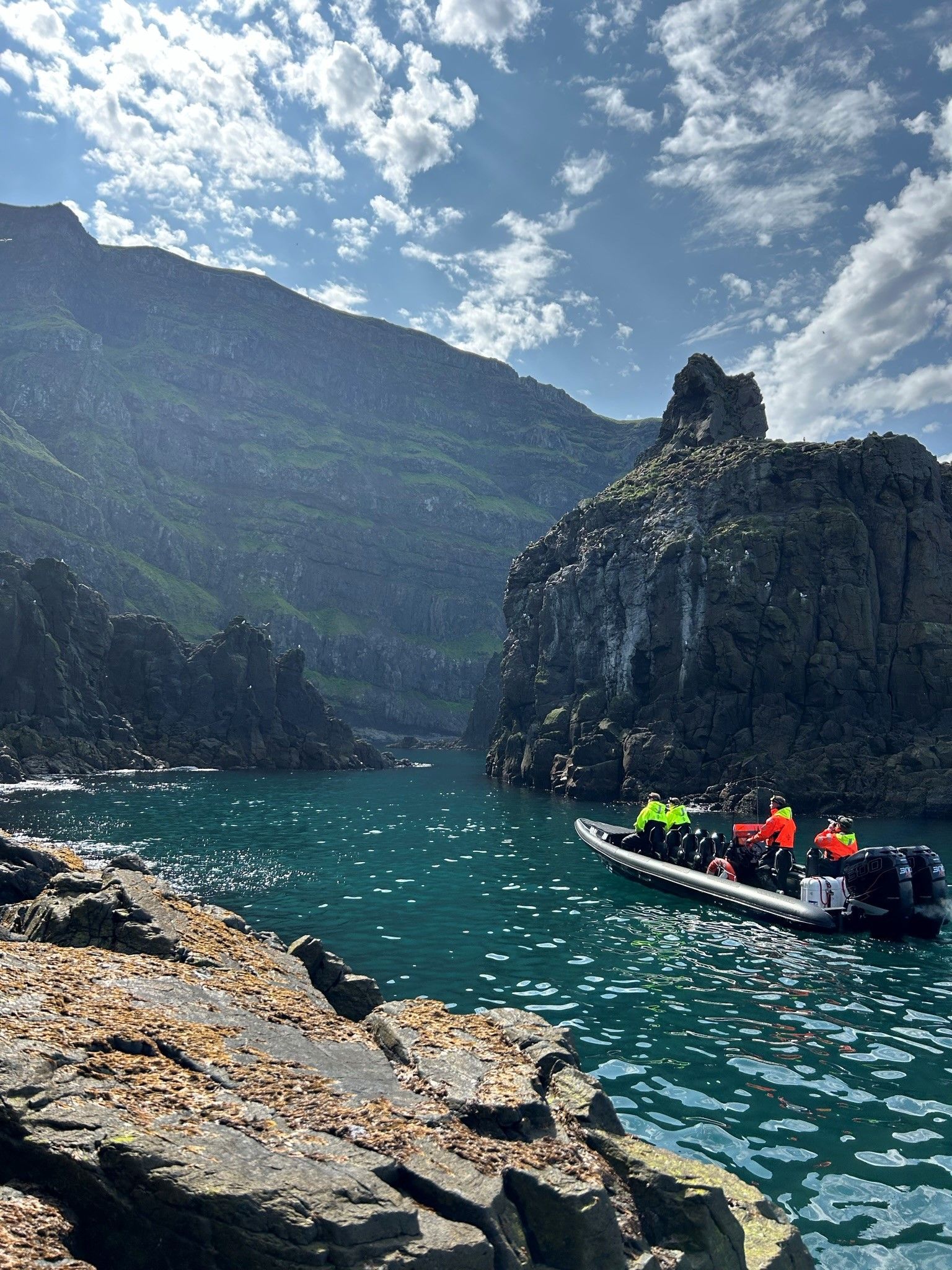 Adventurers on a RIB boat surrounded by the scenic beauty of Sæluvogur