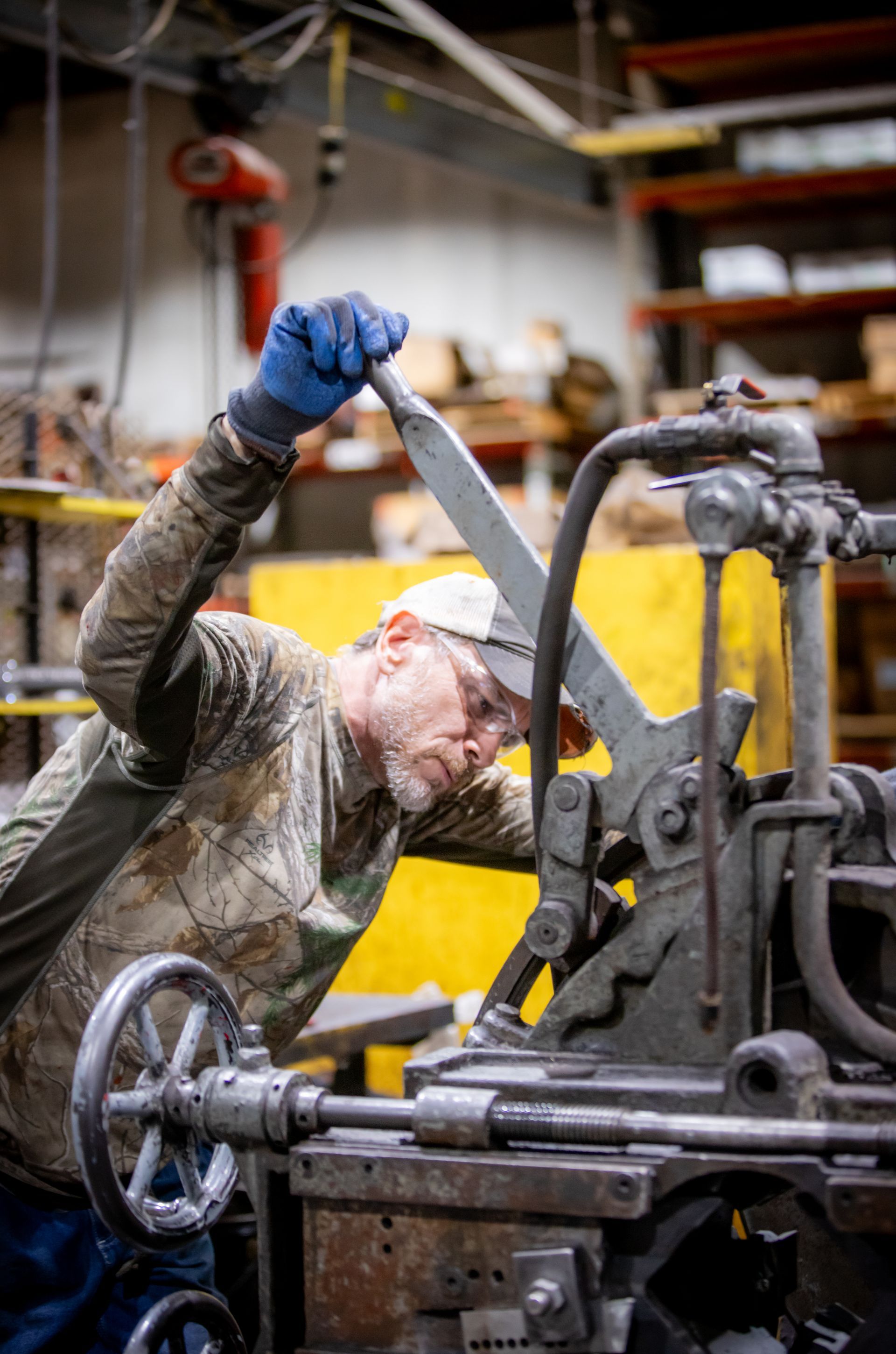 A man is working on a machine in a factory