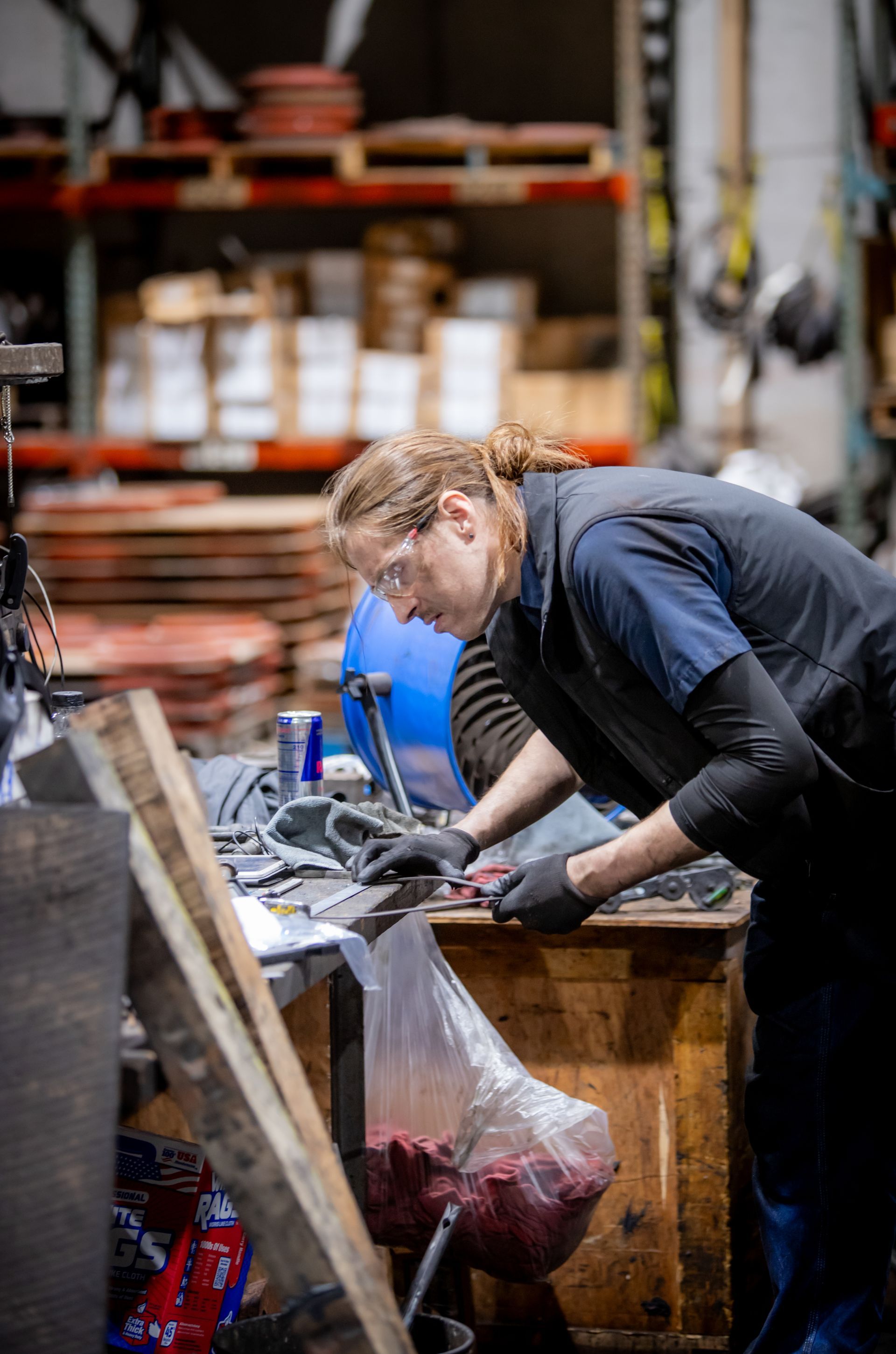 A man is working on a machine in a warehouse.
