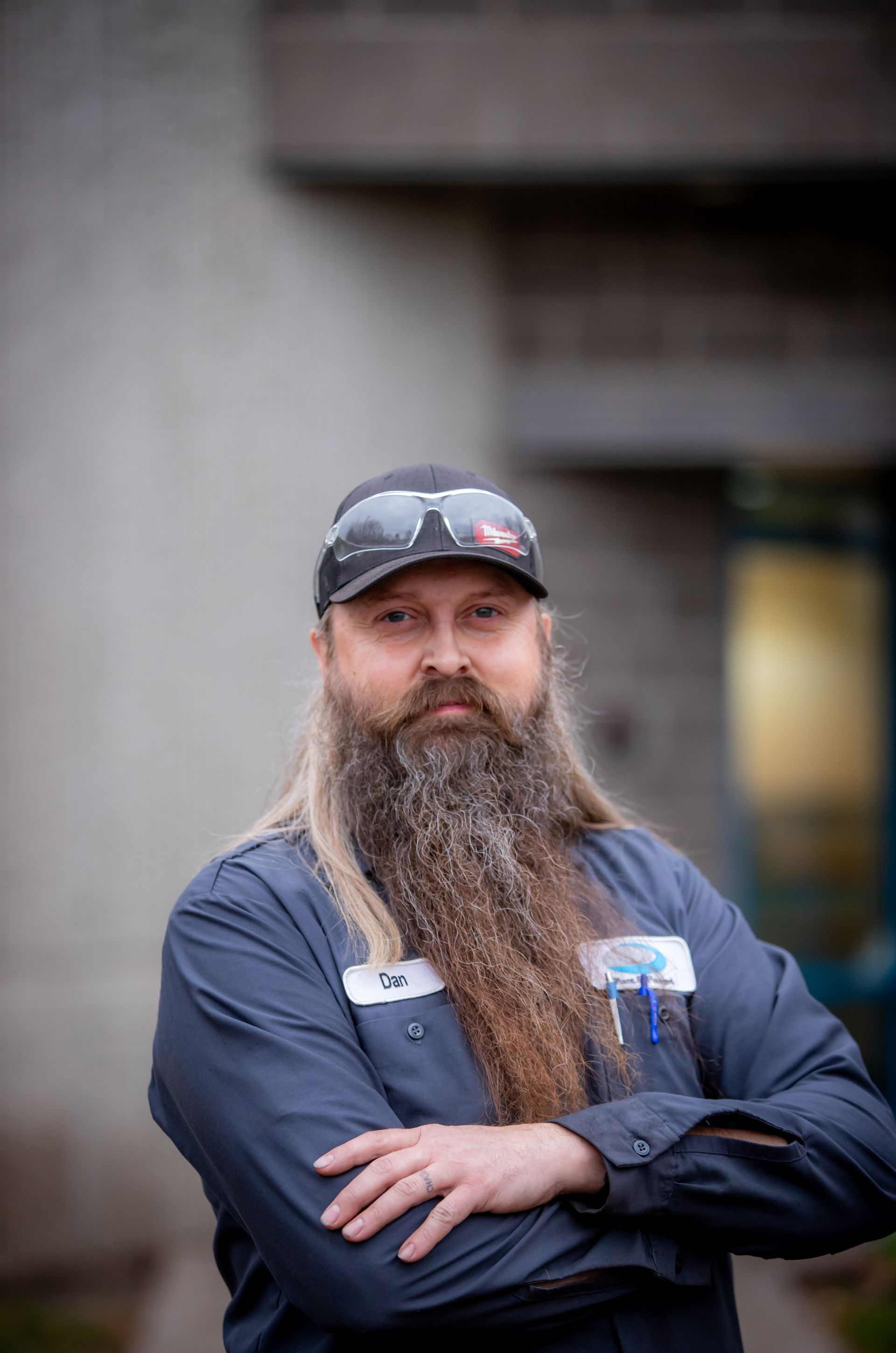 A man with a long beard wearing a hat and sunglasses