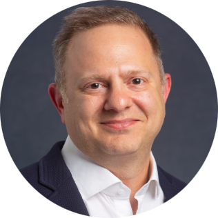 A man in a suit and tie is smiling in a circle