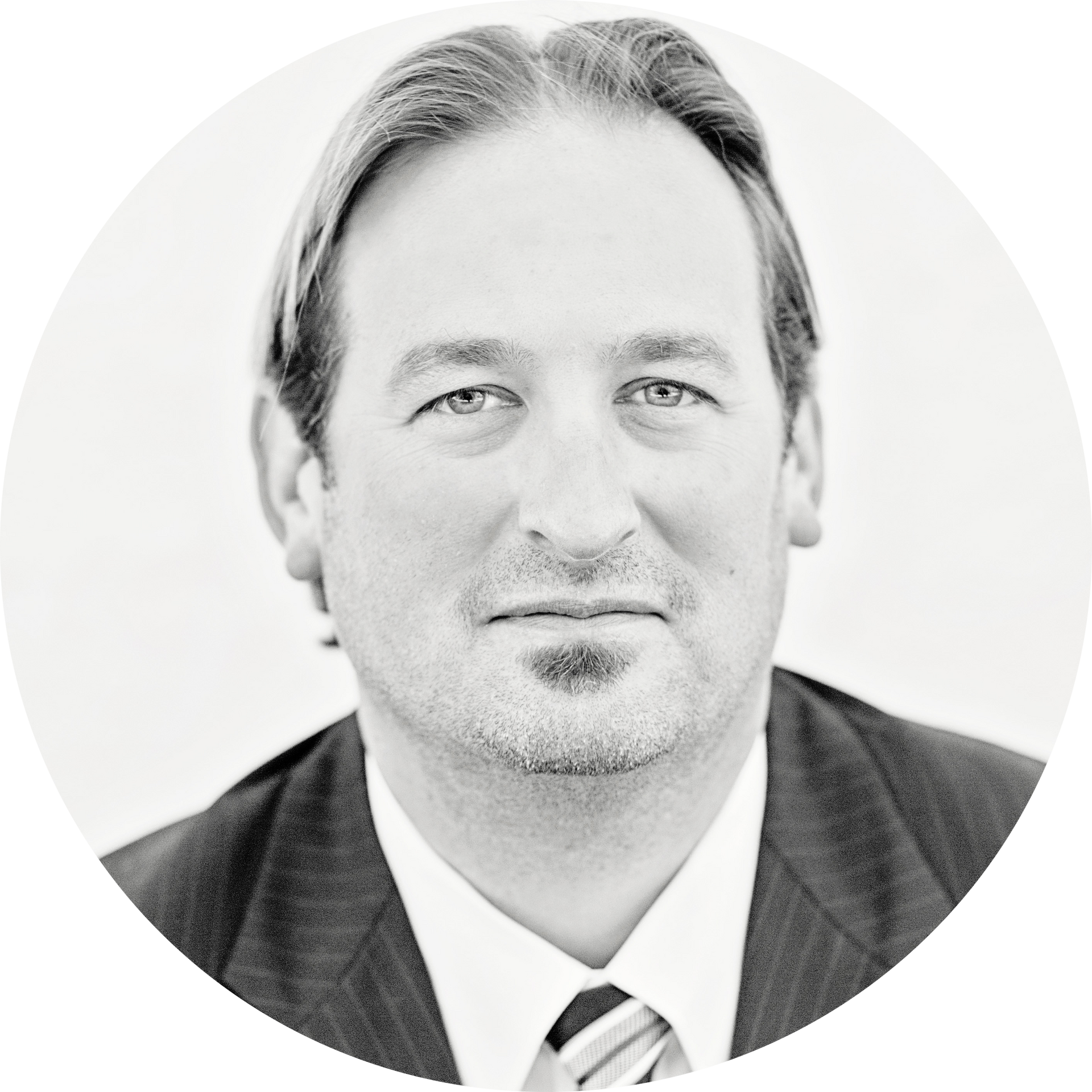 A man in a suit and tie is smiling in a circle