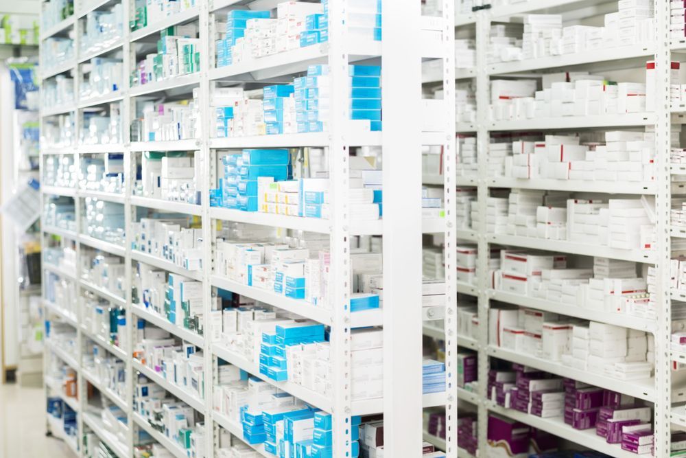 Woman in Pharmacy Holding Magazine and Supplements — Blooms The Chemist Sawtell in Sawtell, NSW
