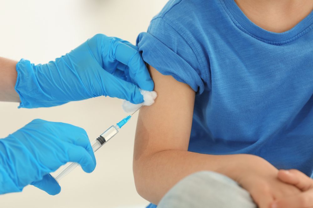 Person in Blue Shirt Receives a Vaccine in Their Arm — Blooms The Chemist Sawtell in Sawtell, NSW
