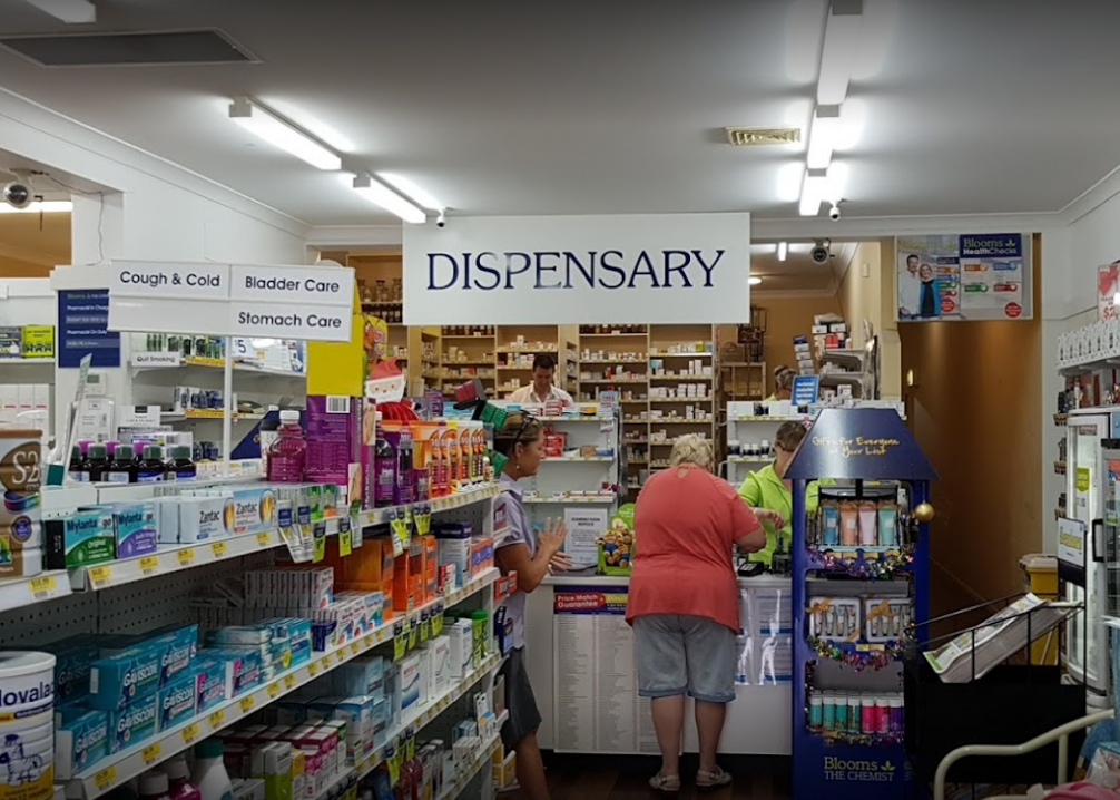 A Pharmacist Wearing a Hijab Smiles at a Customer in a Pharmacy — Blooms The Chemist Sawtell in Sawtell, NSW