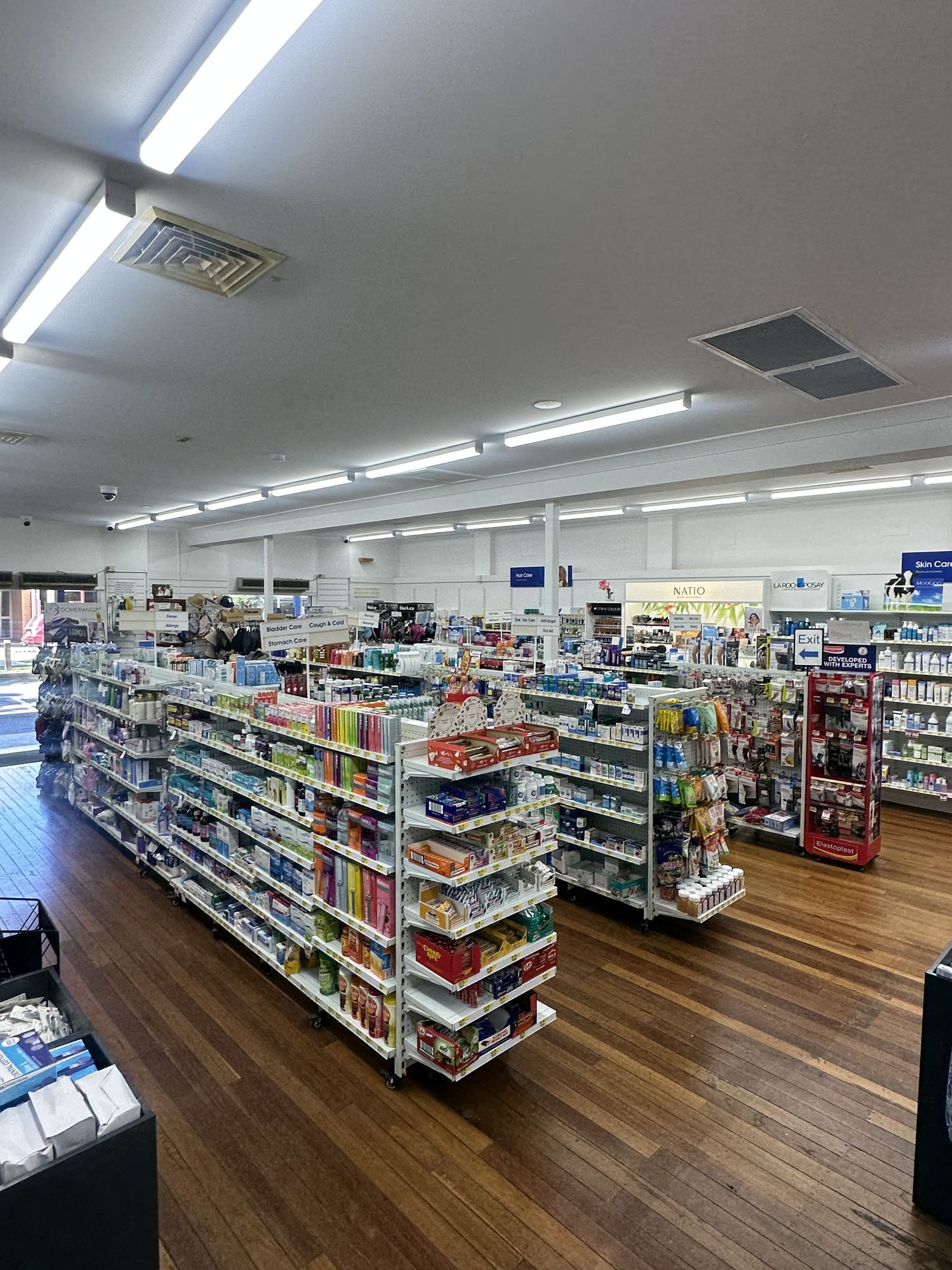 A Pharmacy Interior With Rows of Shelves Stocked With Products — Blooms The Chemist Sawtell in Sawtell, NSW