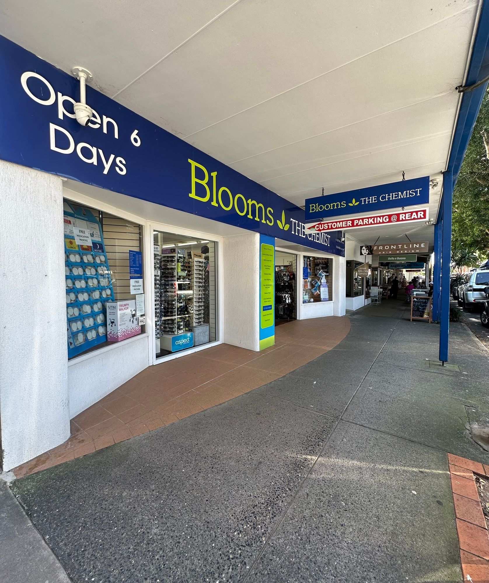 Blooms the Chemist Storefront With Cars Parked on a Sunny Day — Blooms The Chemist Sawtell in Sawtell, NSW