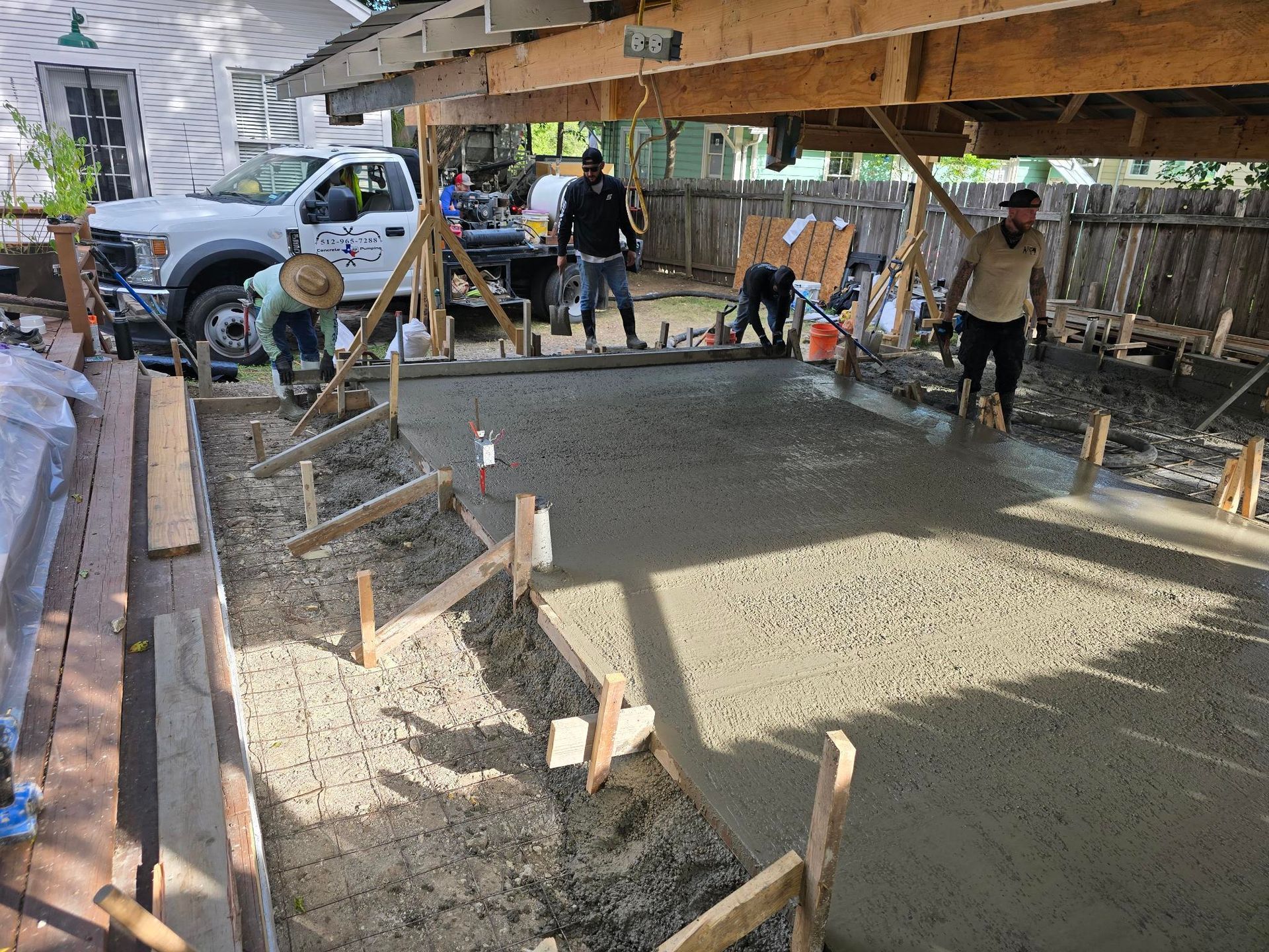 A white house with a table and chairs in front of it