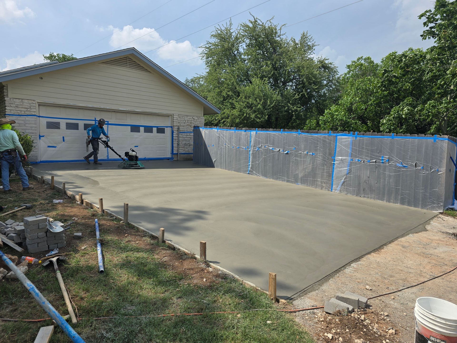 A red car is parked in front of a modern house.