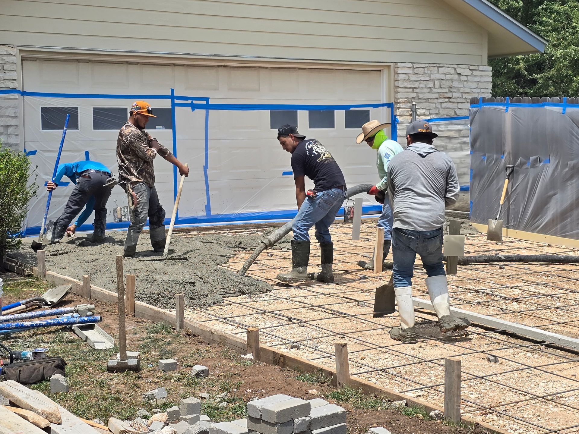 A red car is parked in front of a modern house.