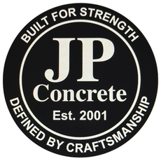 The logo for quality assured construction llc is a green hexagon with a hammer and trowel in it.