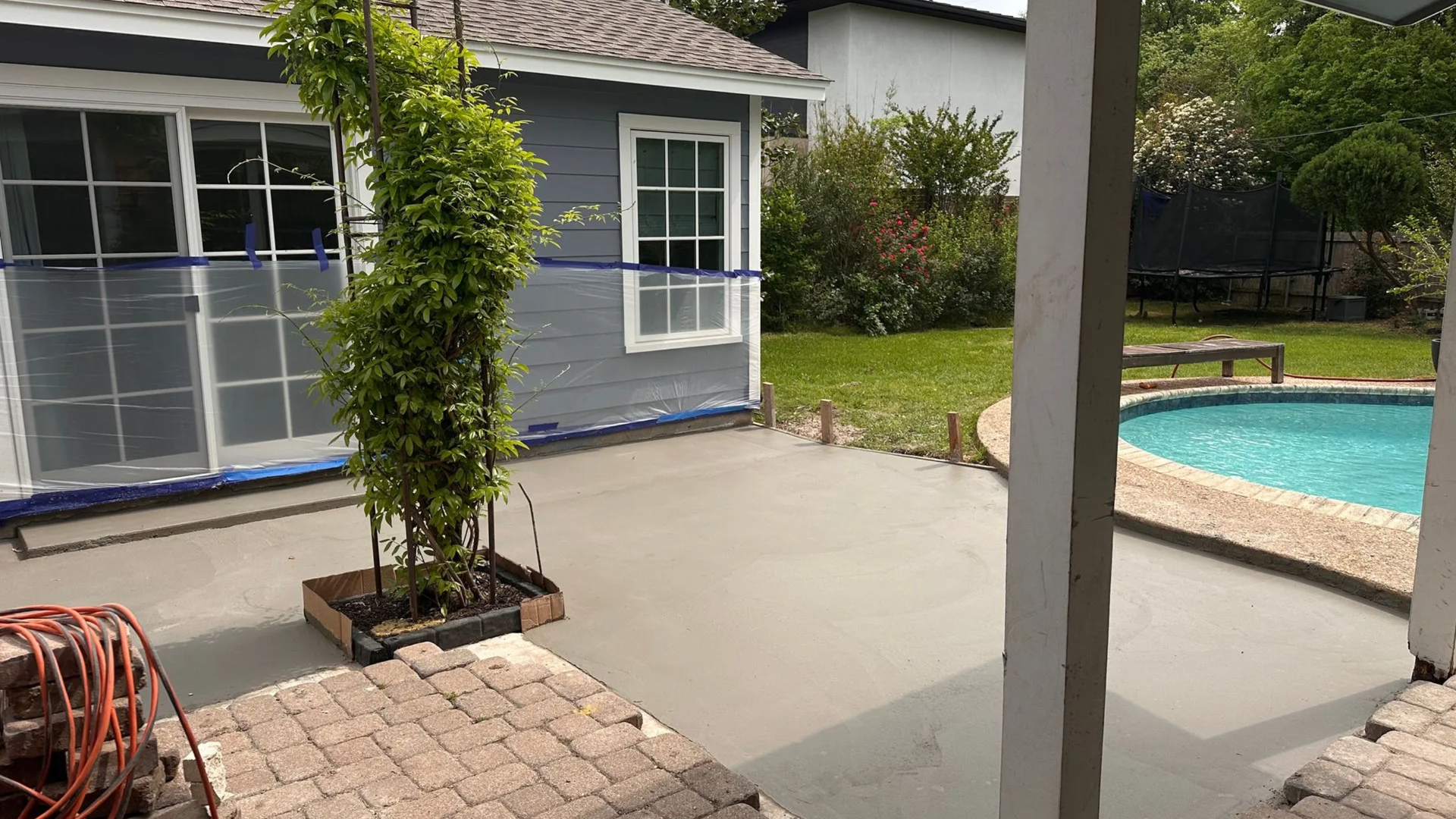 Concrete patio installation with decorative finish at an Austin home.