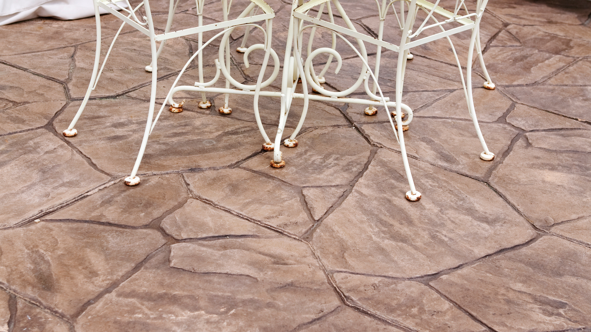 Decorative stamped concrete patio featuring popular stone patterns installed at a residential home 