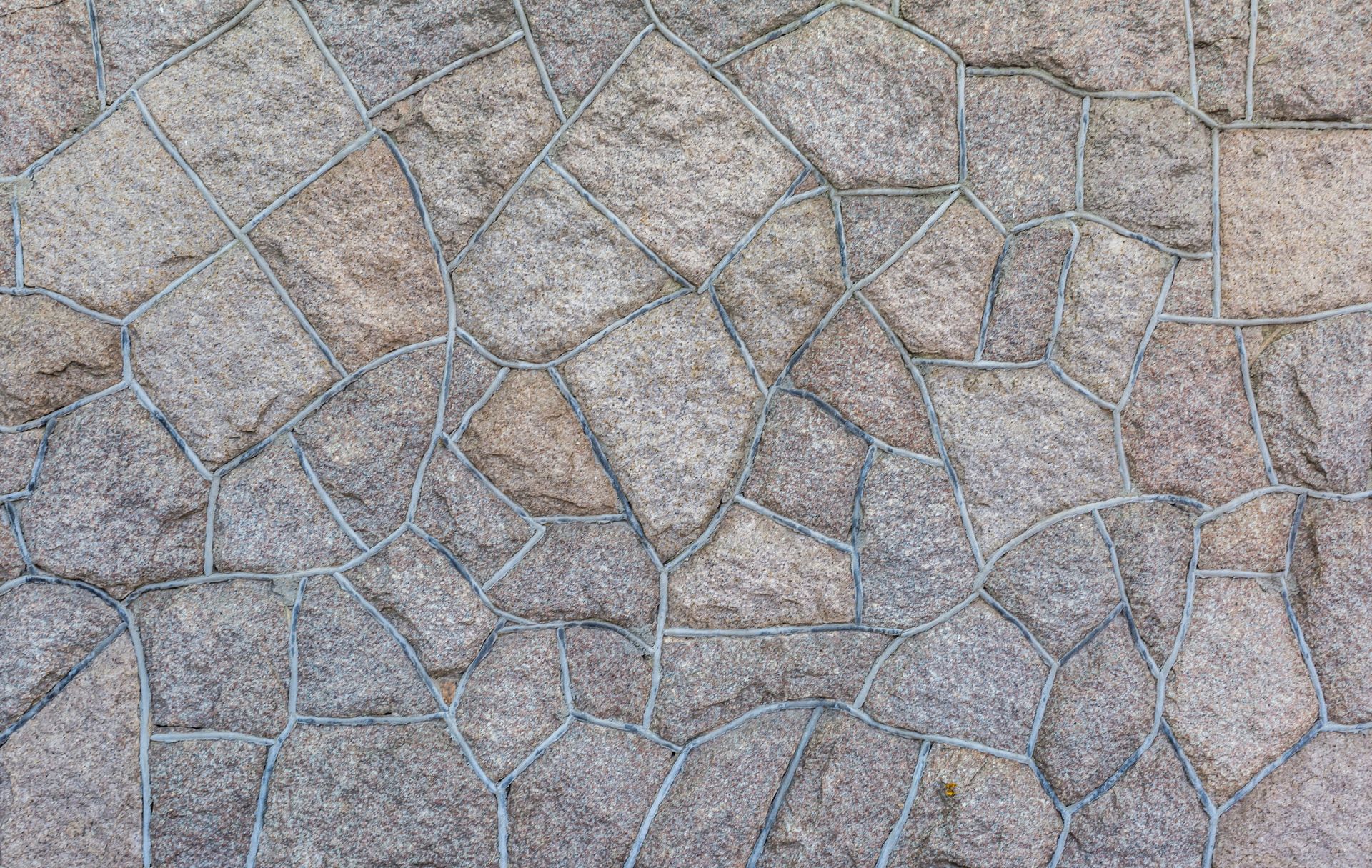A close up of a stone wall with a geometric pattern.