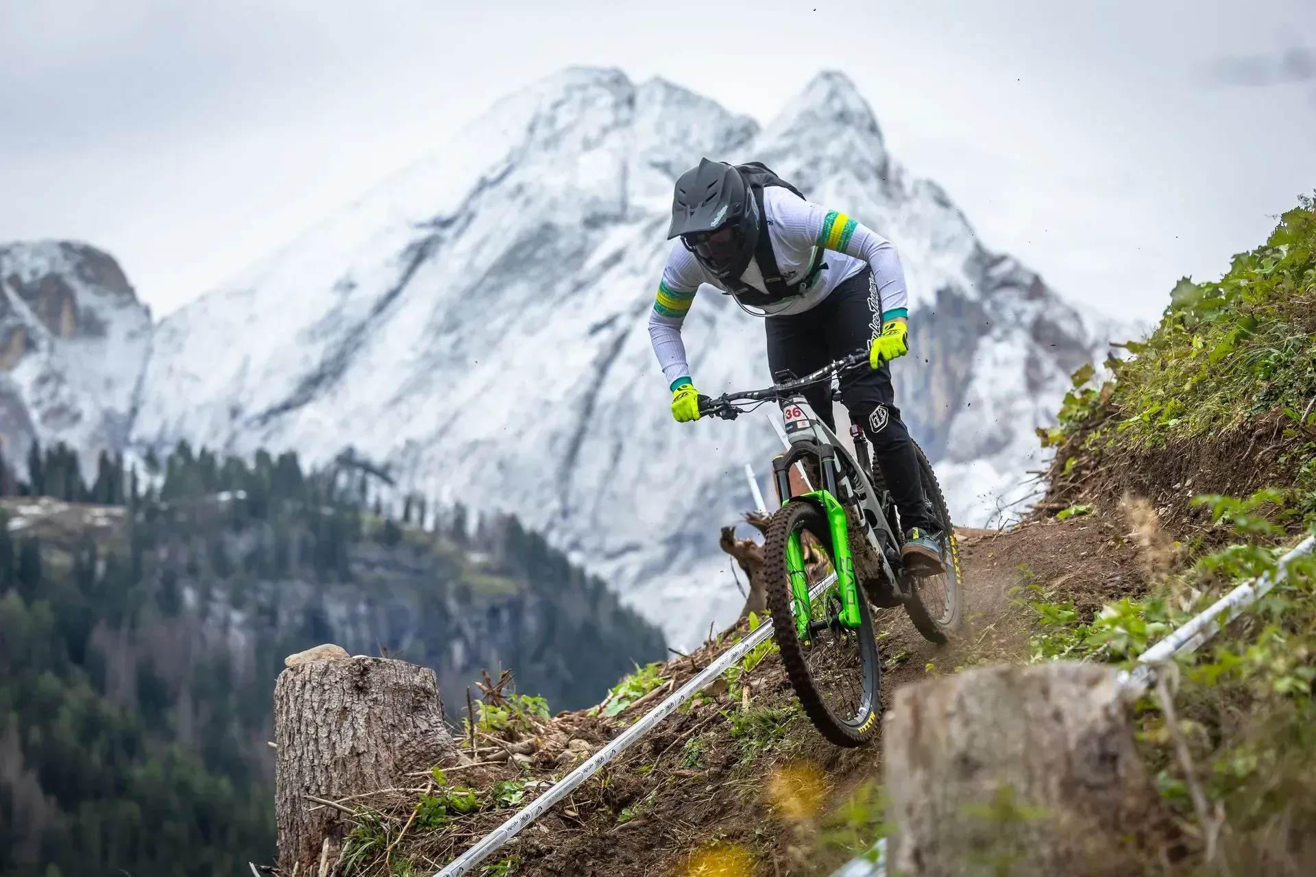 A man is riding a mountain bike down a trail in the mountains.