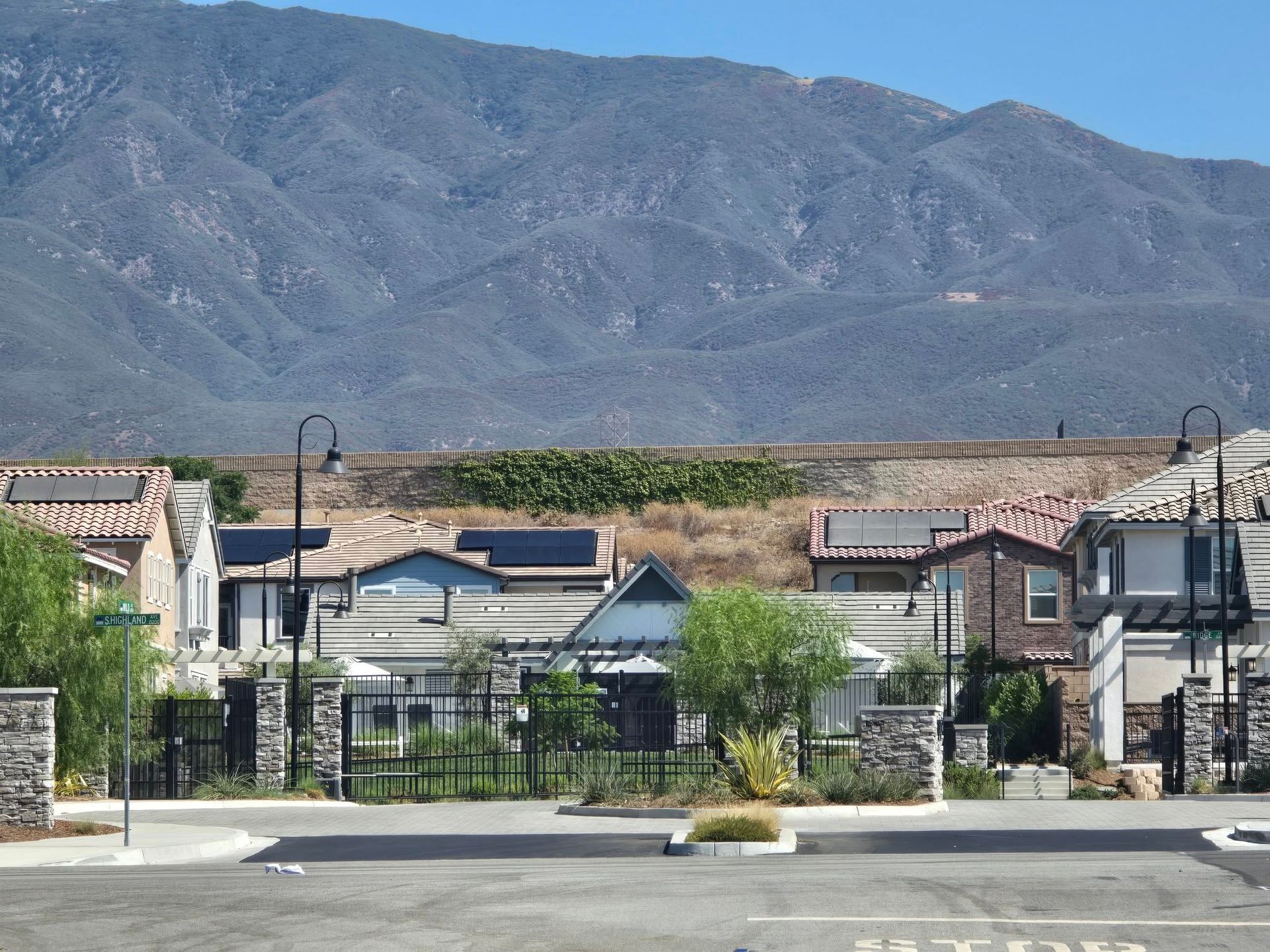 A row of houses with mountains in the background