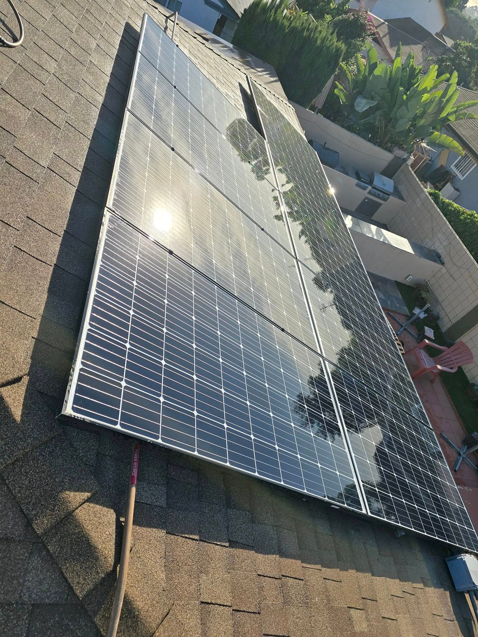 A bunch of solar panels are sitting on top of a roof.