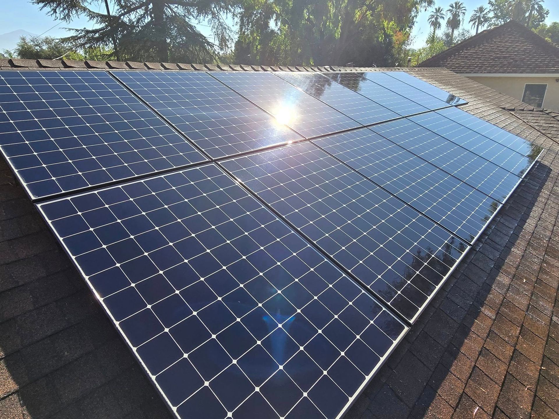 The sun is shining through the solar panels on the roof