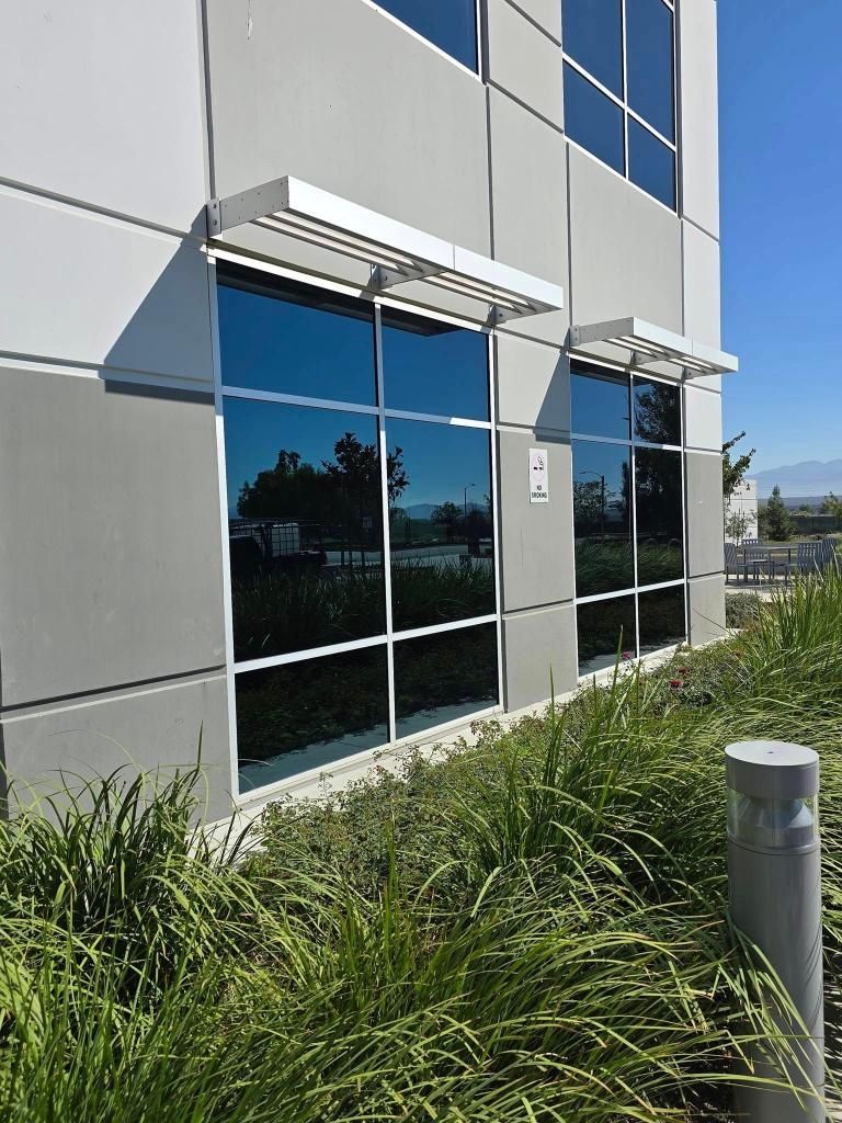 A building with a lot of windows and a canopy on the side of it.