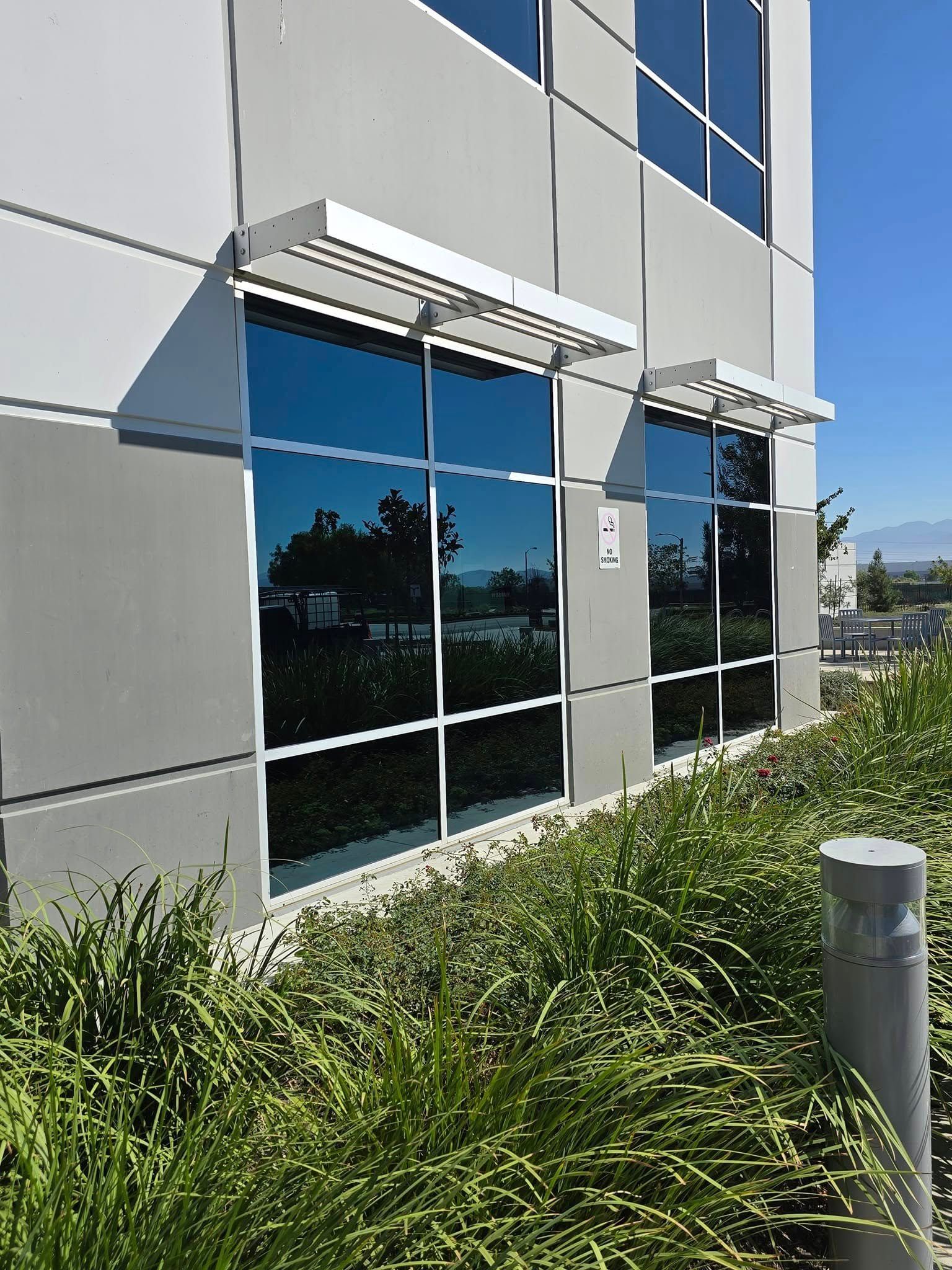 A building with a lot of windows and a canopy on the side of it.