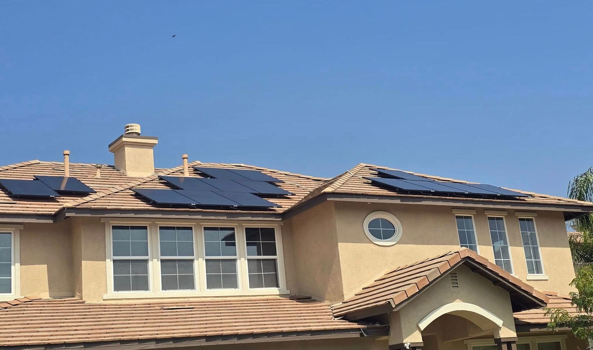 A large house with solar panels on the roof.